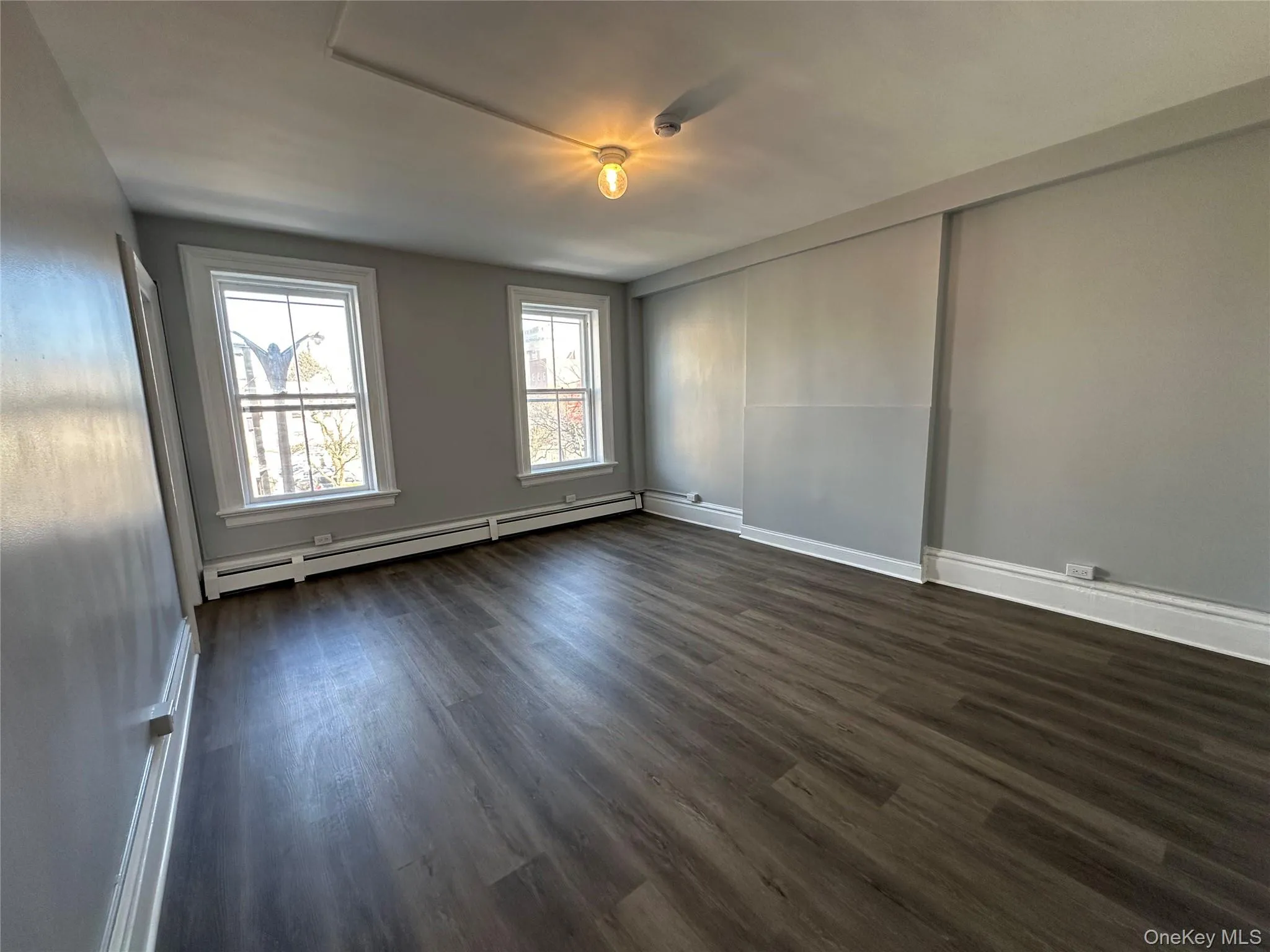 Living Room w/ Big Windows & Luxury Vinyl Plank Flooring Living Room w/ Big Windows & Luxury Vinyl Plank Flooring