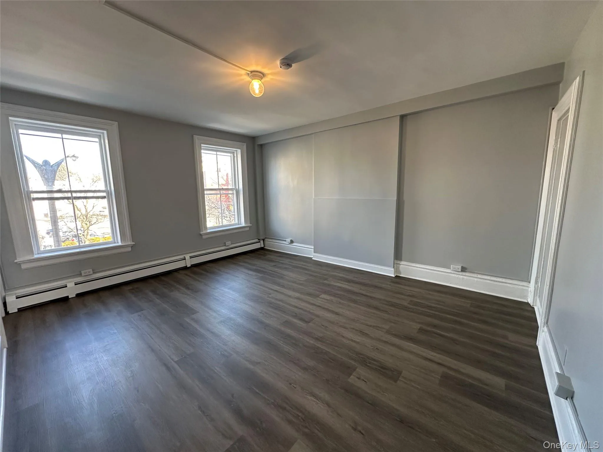 Living Room w/ Big Windows & Luxury Vinyl Plank Flooring Living Room w/ Big Windows & Luxury Vinyl Plank Flooring