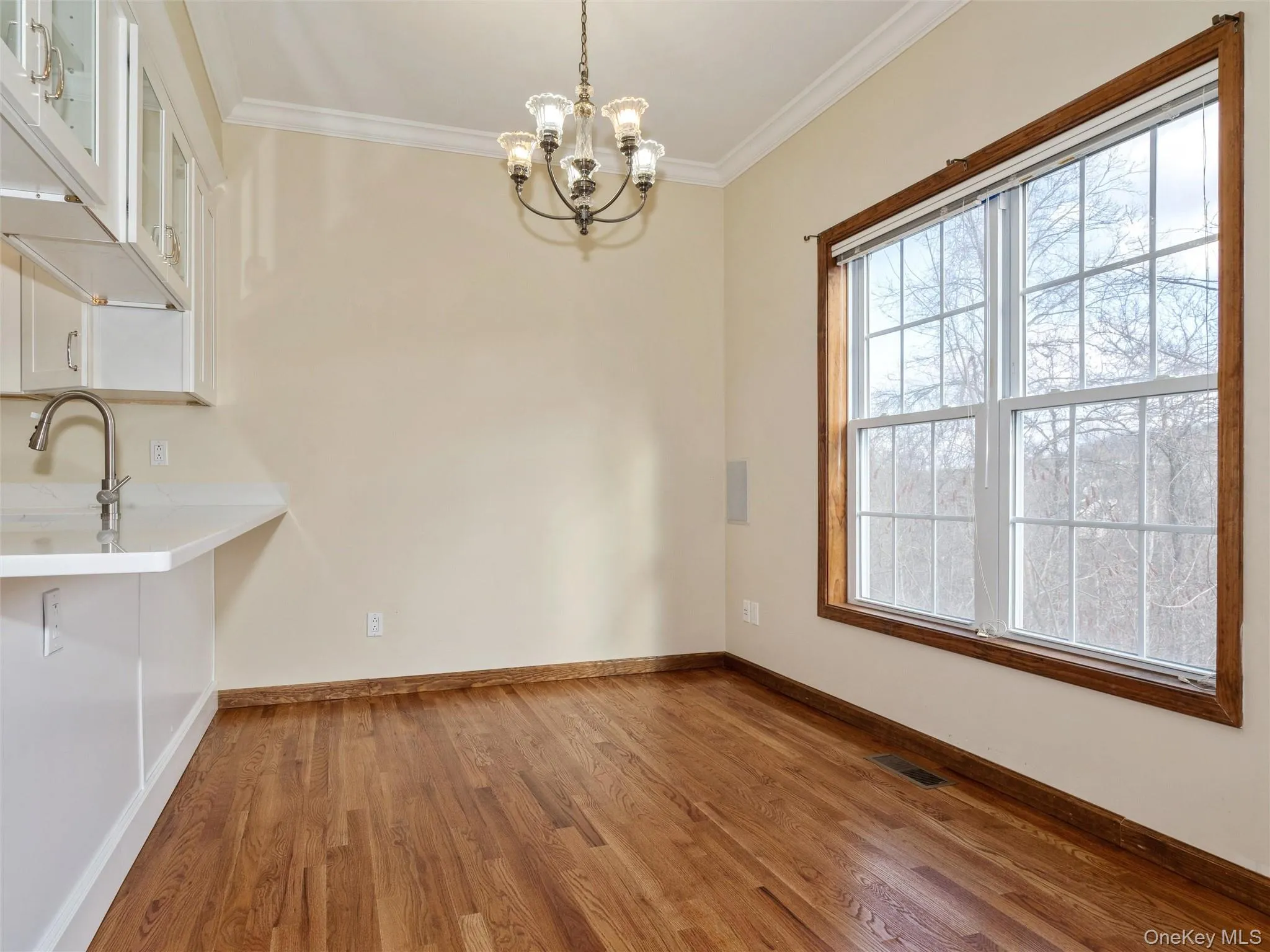 Dining area with large window overlooking the mountains, chandelier Dining area with large window overlooking the mountains, chandelier
