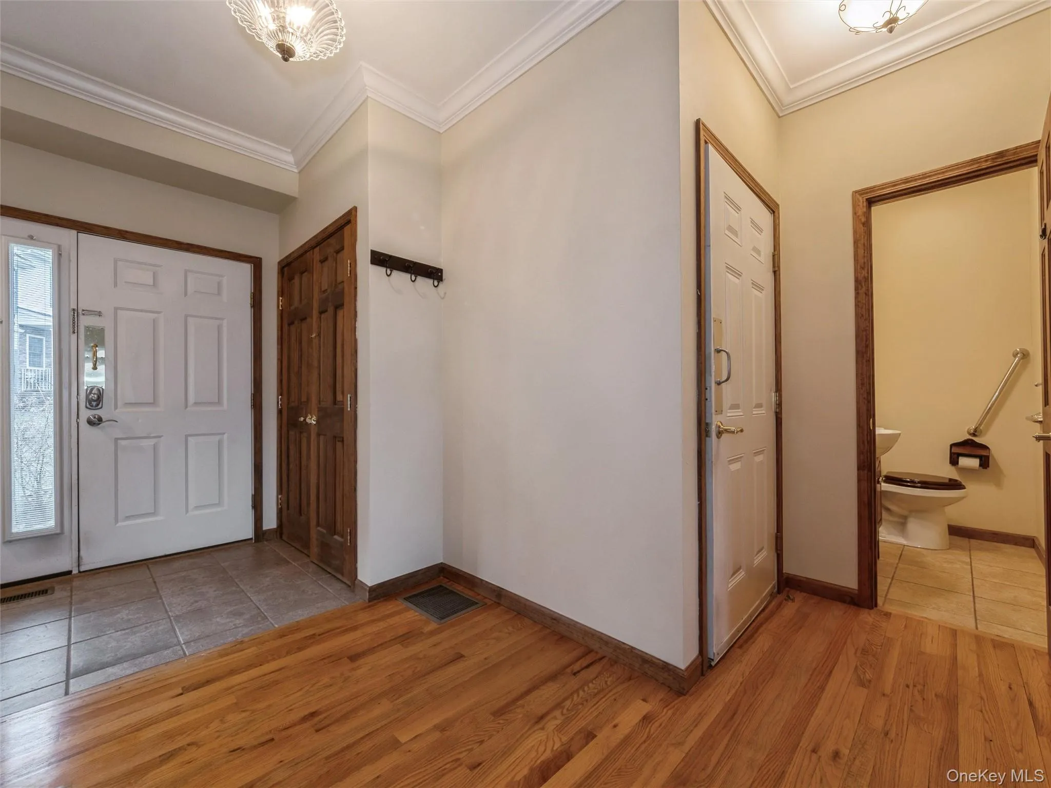Entrance hall, large coat closet, half bath, door to garage. Entrance hall, large coat closet, half bath, door to garage.