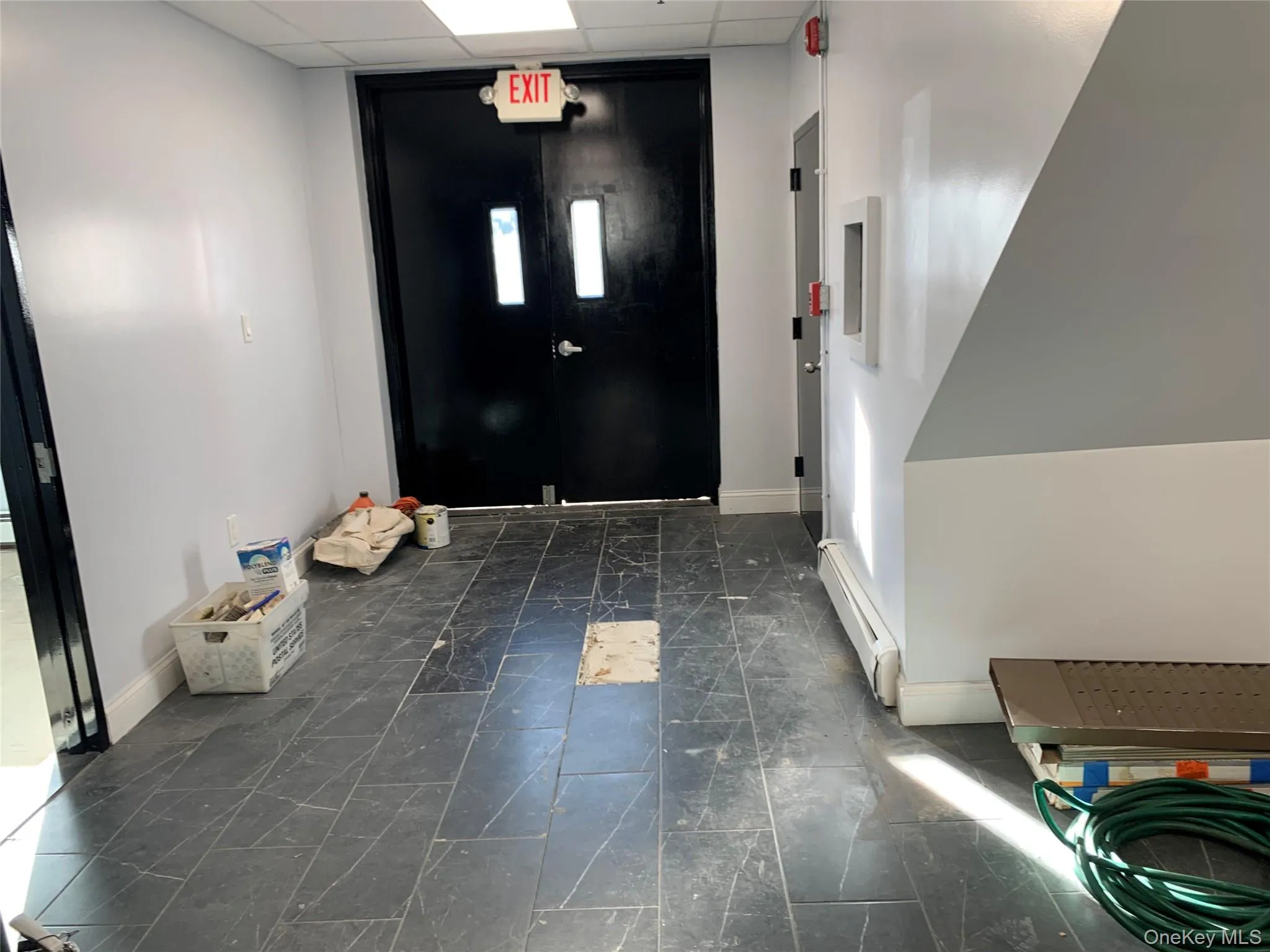 Entrance foyer with a drop ceiling and a baseboard radiator Entrance foyer with a drop ceiling and a baseboard radiator