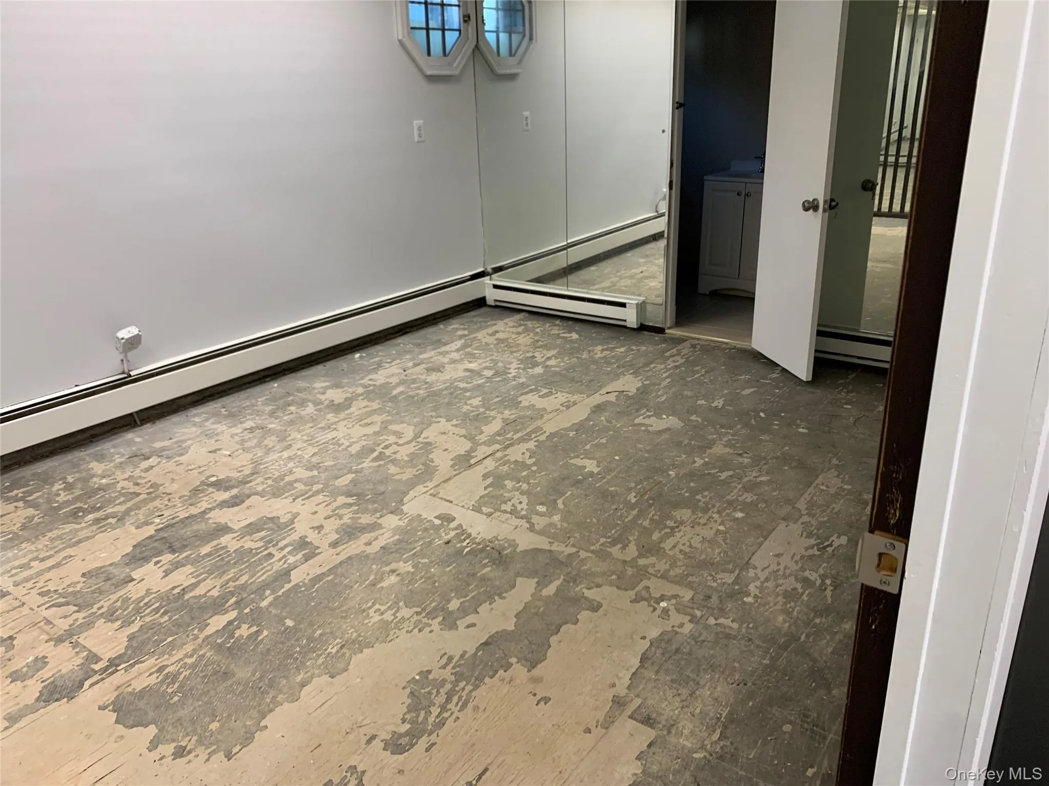 Below grade area with a baseboard heating unit and baseboard heating Below grade area with a baseboard heating unit and baseboard heating