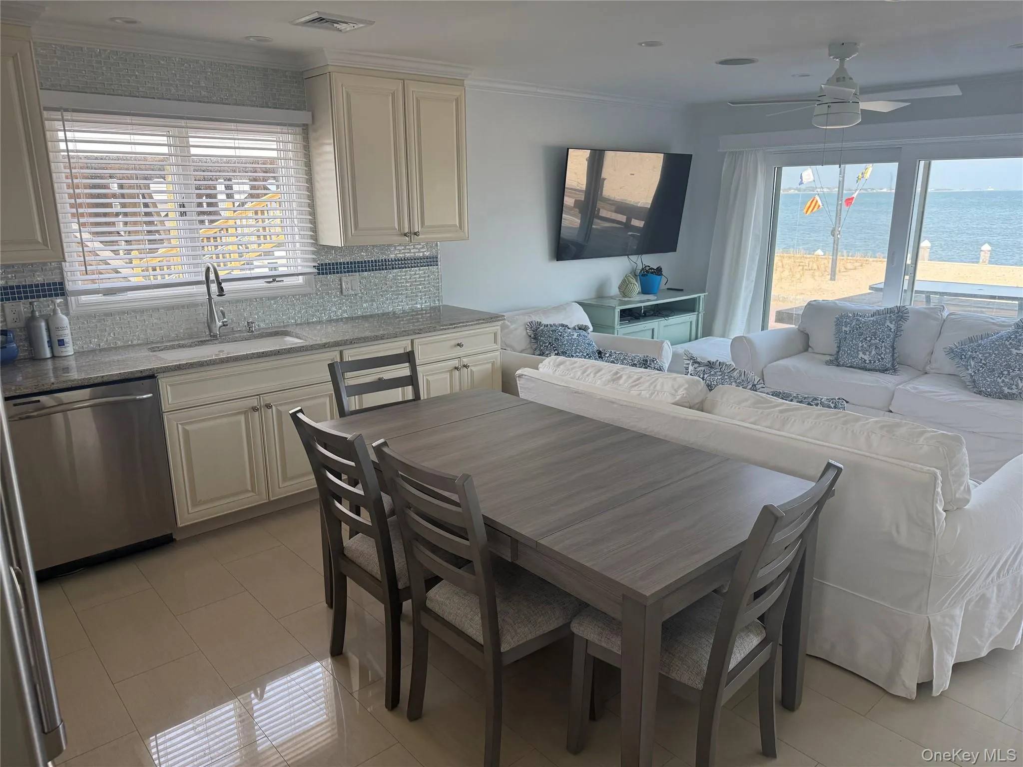 Dining room with a ceiling fan, crown molding, visible vents, and plenty of natural light Dining room with a ceiling fan, crown molding, visible vents, and plenty of natural light