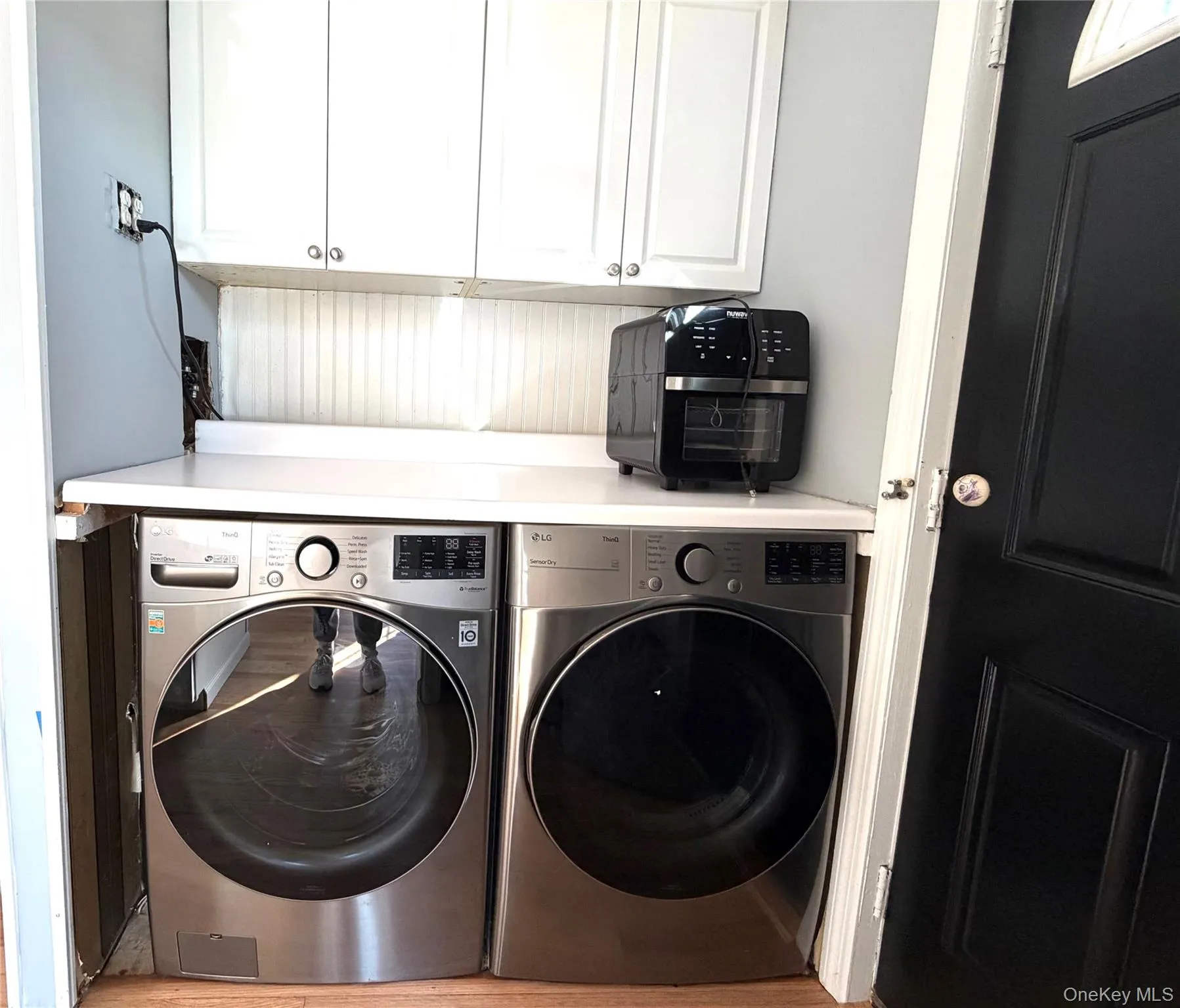 Laundry area featuring cabinet space and separate washer and dryer Laundry area featuring cabinet space and separate washer and dryer