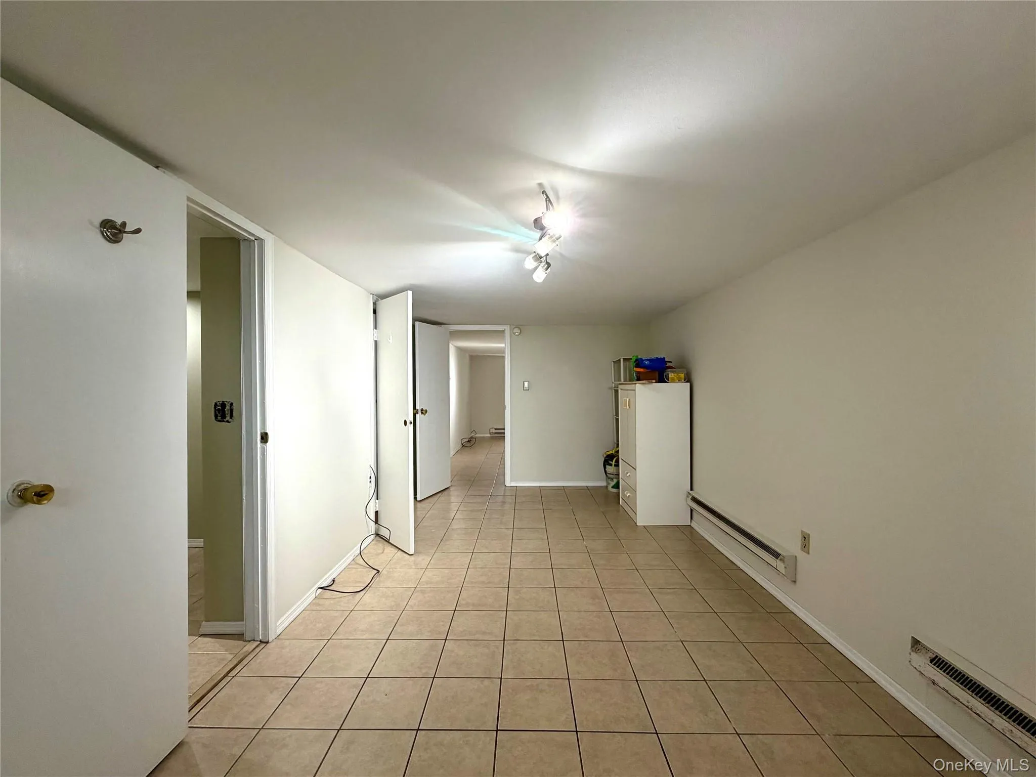 large, finished room in basement with tile flooring large, finished room in basement with tile flooring