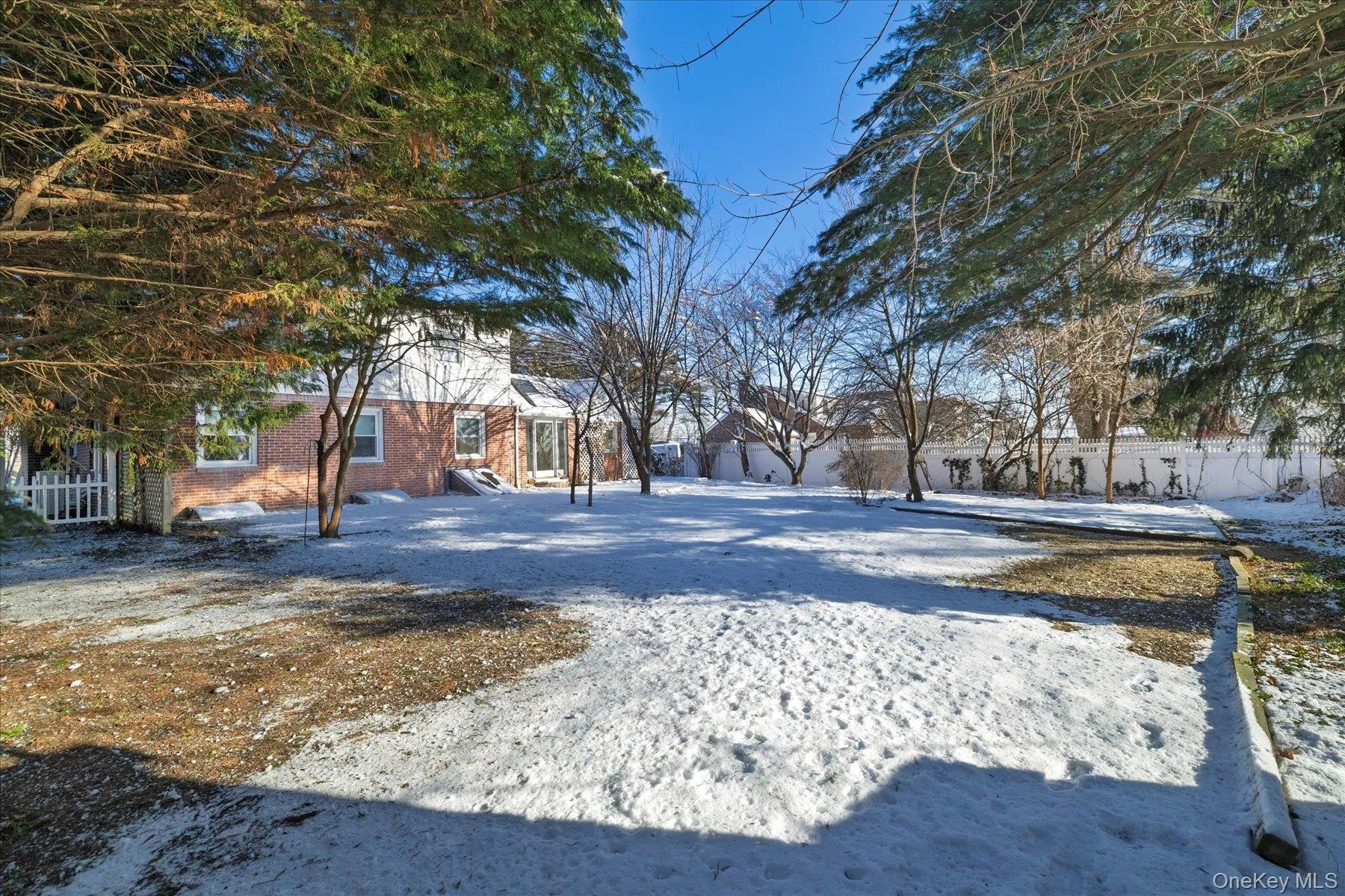 View of yard layered in snow View of yard layered in snow