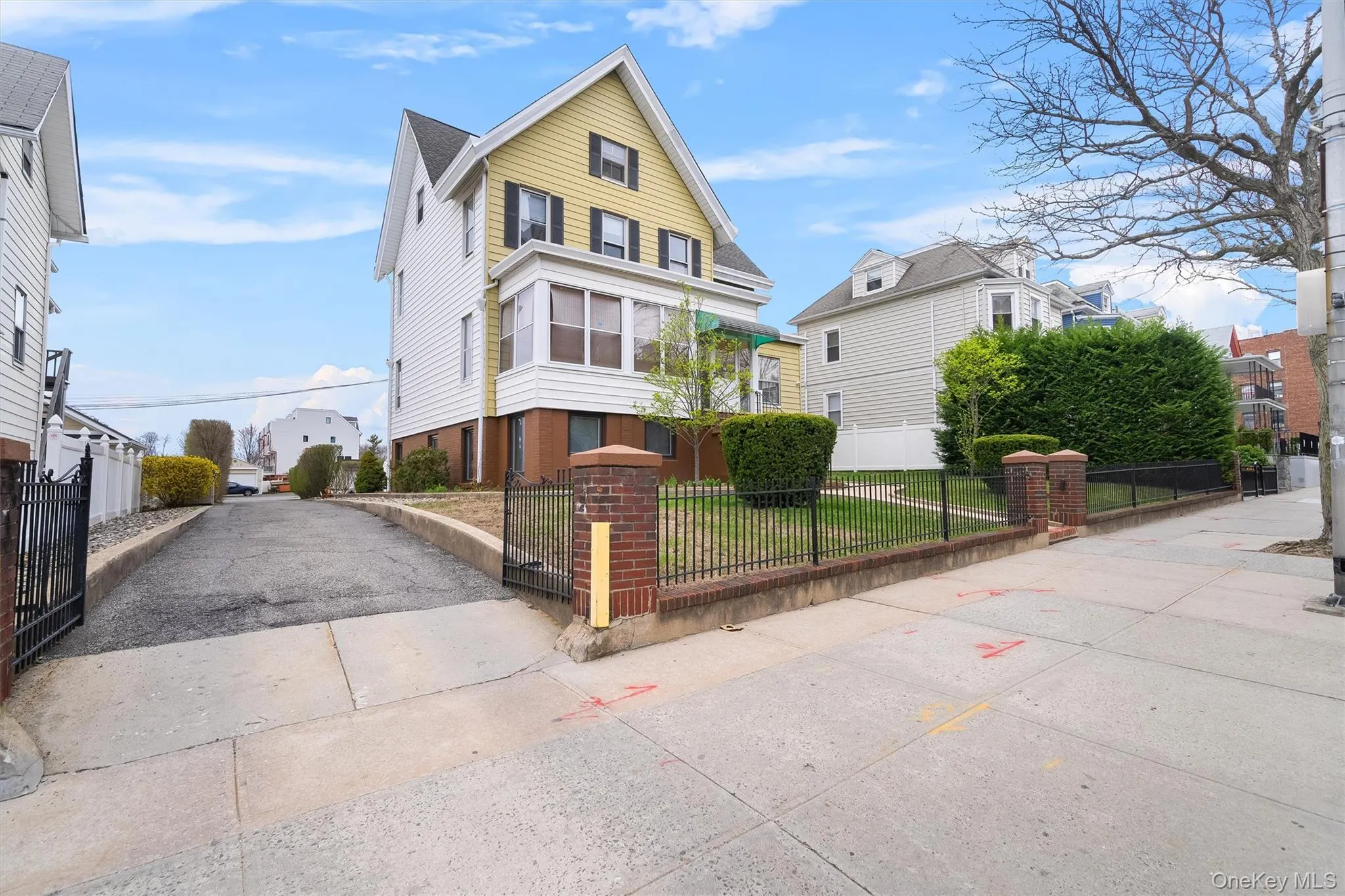 View of front of house featuring a fenced front yard and a residential view View of front of house featuring a fenced front yard and a residential view