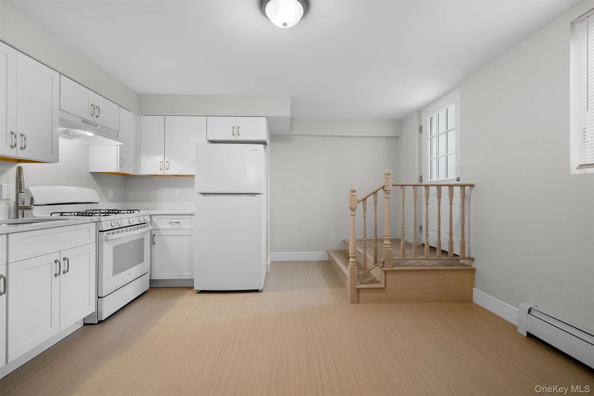 Renovated eat in Kitchen with quartz counters & with door to yard Renovated eat in Kitchen with quartz counters & with door to yard