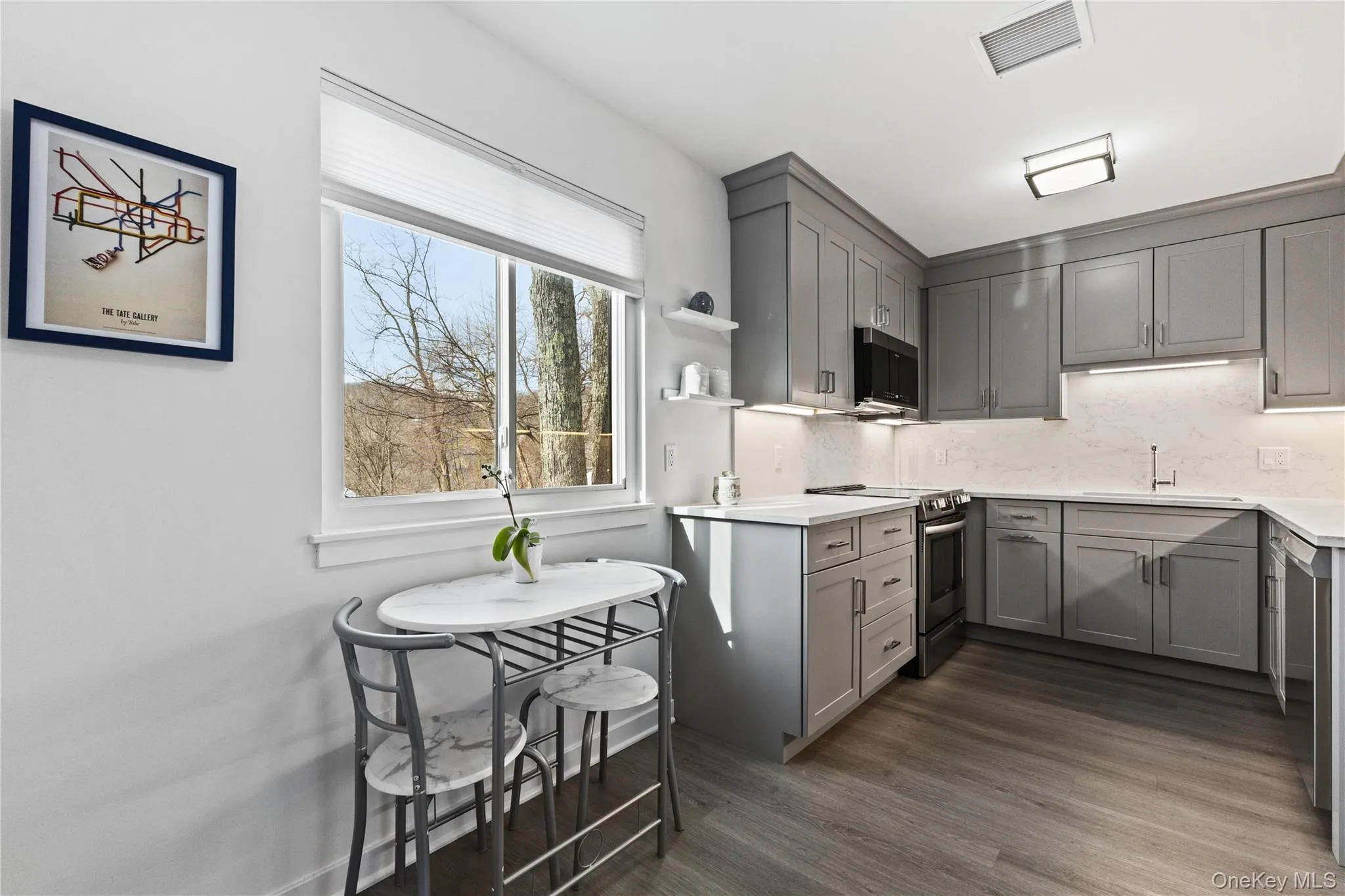 Dine-in-Kitchen with large window. Custom Cabinets with crown-molding. Brazilian wood-laminate floor. Dine-in-Kitchen with large window. Custom Cabinets with crown-molding. Brazilian wood-laminate floor.