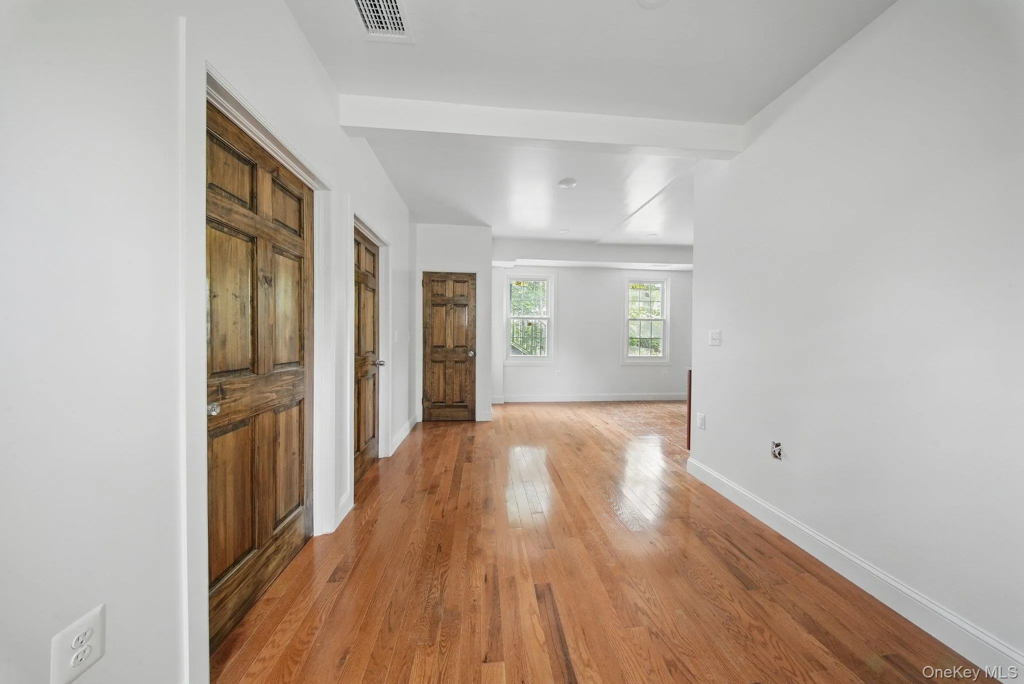 Living room with wood floors, great natural light and recessed lighting Living room with wood floors, great natural light and recessed lighting