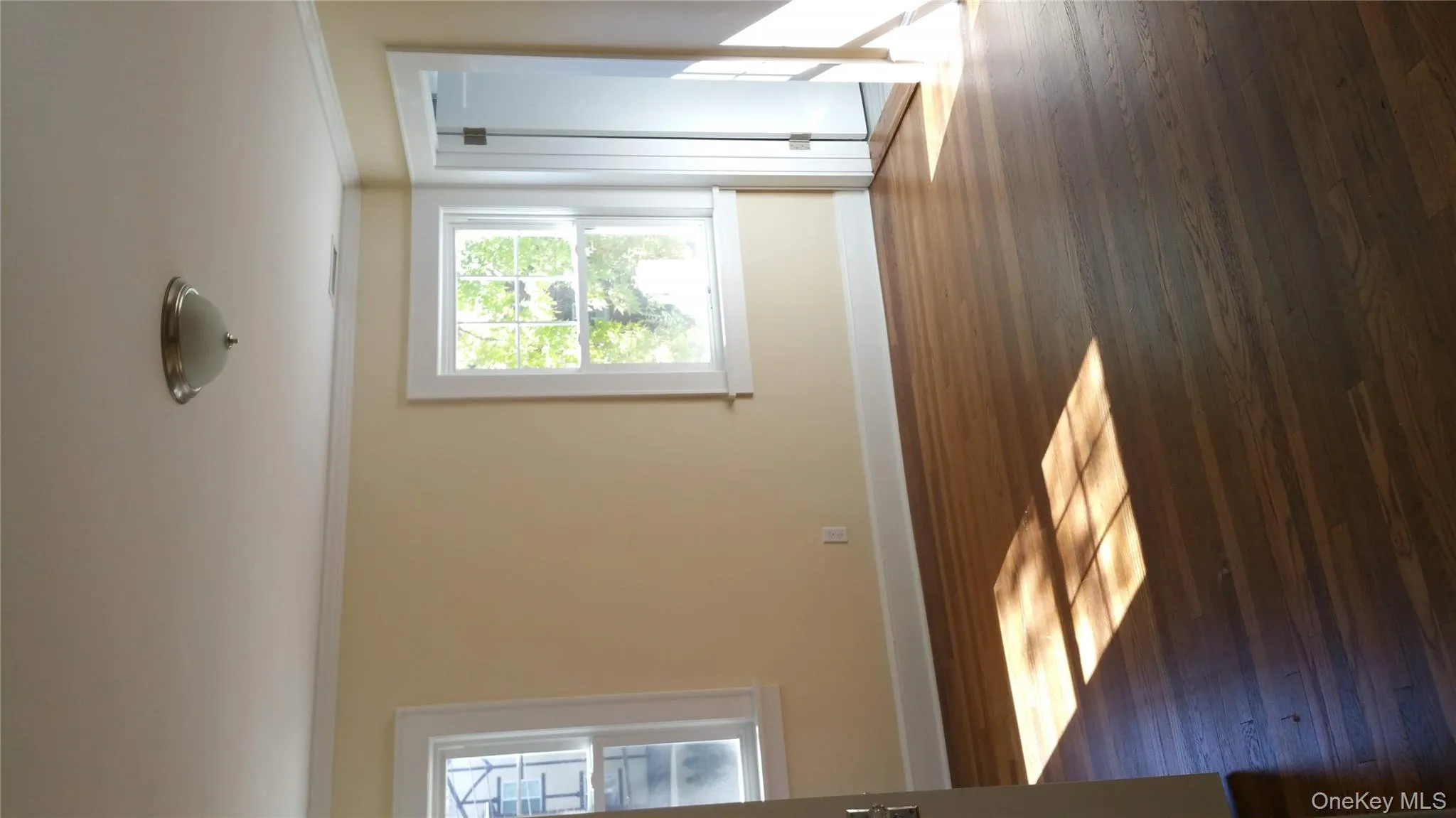 Unfurnished room featuring crown molding and wood finished floors Unfurnished room featuring crown molding and wood finished floors