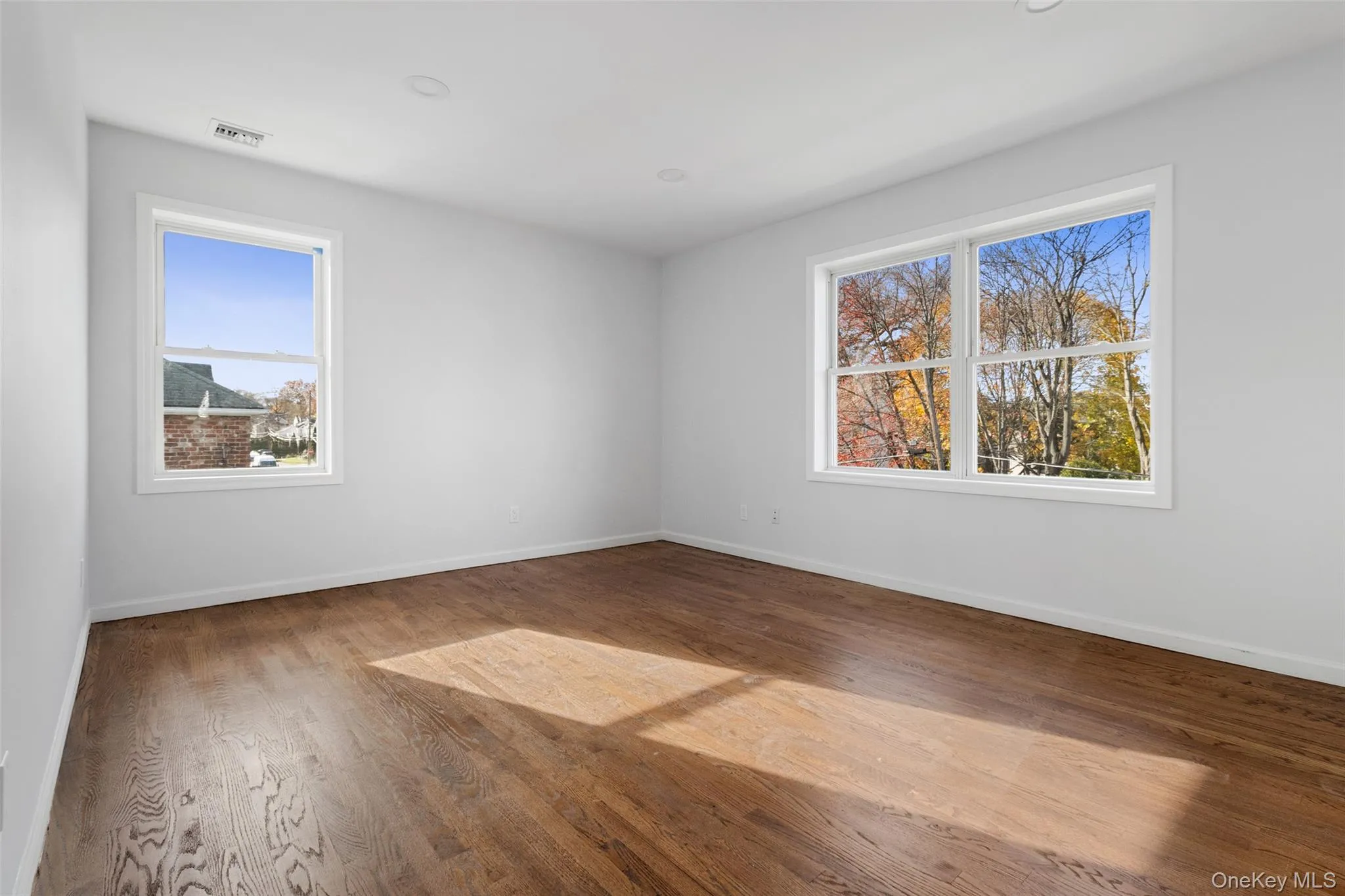 Spare room featuring wood finished floors and recessed lighting Spare room featuring wood finished floors and recessed lighting
