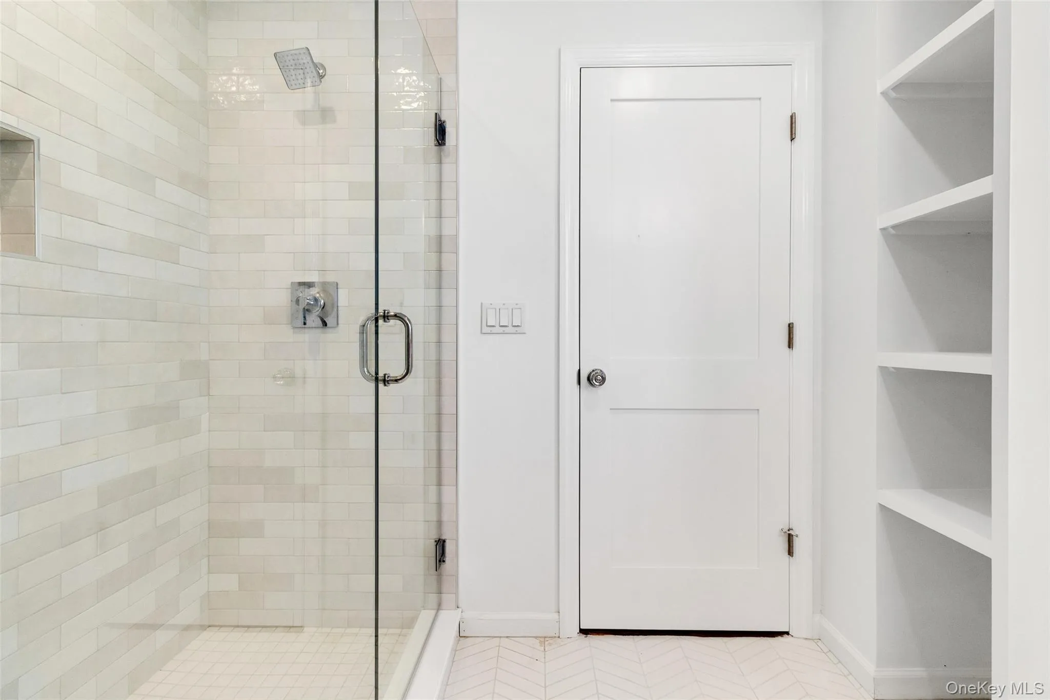 Bathroom with a shower stall and tile patterned floors Bathroom with a shower stall and tile patterned floors