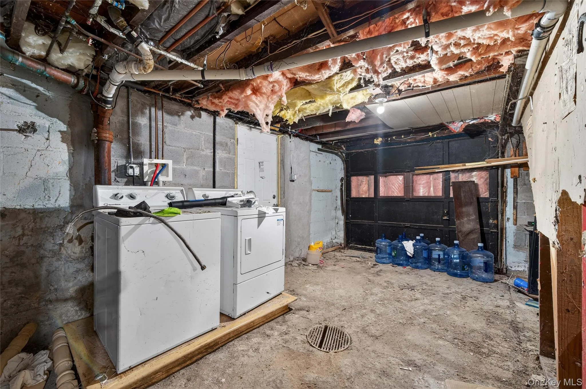 Unfinished below grade area with separate washer and dryer Unfinished below grade area with separate washer and dryer