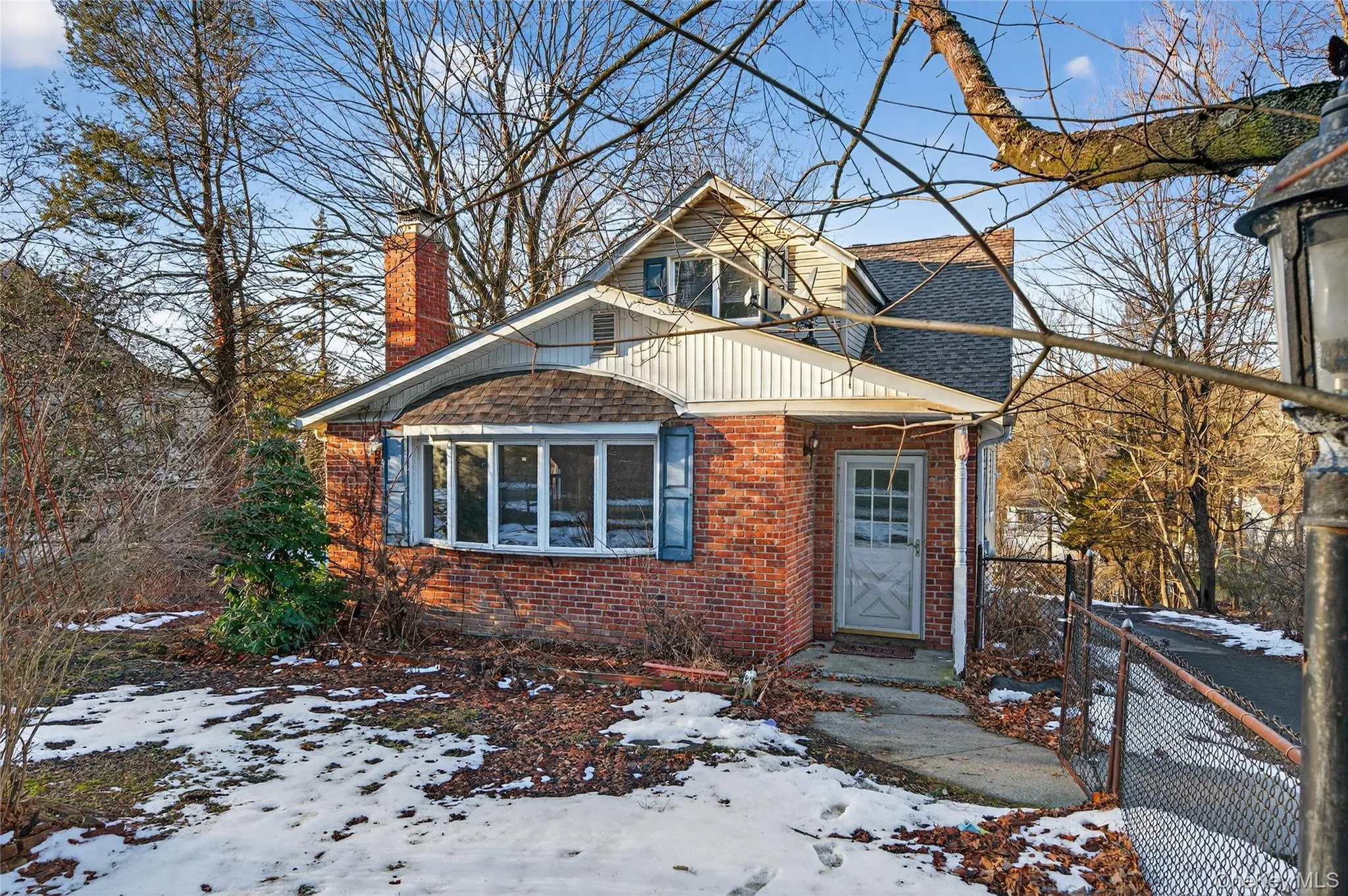 View of front of home with a chimney, brick siding, and a shingled roof View of front of home with a chimney, brick siding, and a shingled roof