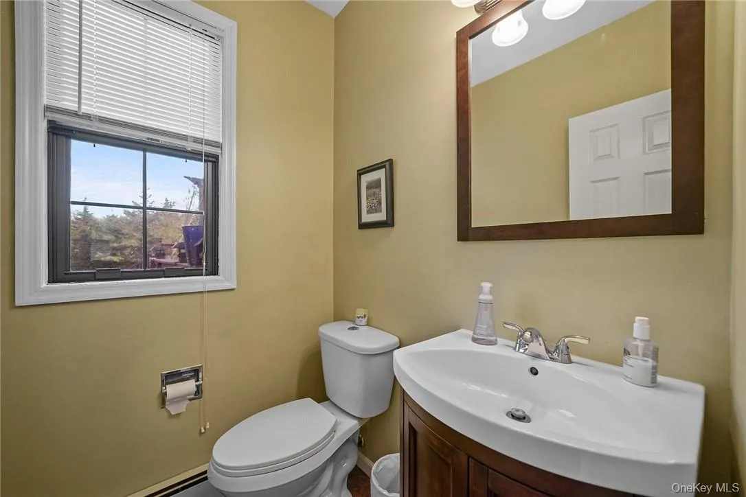 Bathroom featuring vanity and a baseboard radiator Bathroom featuring vanity and a baseboard radiator