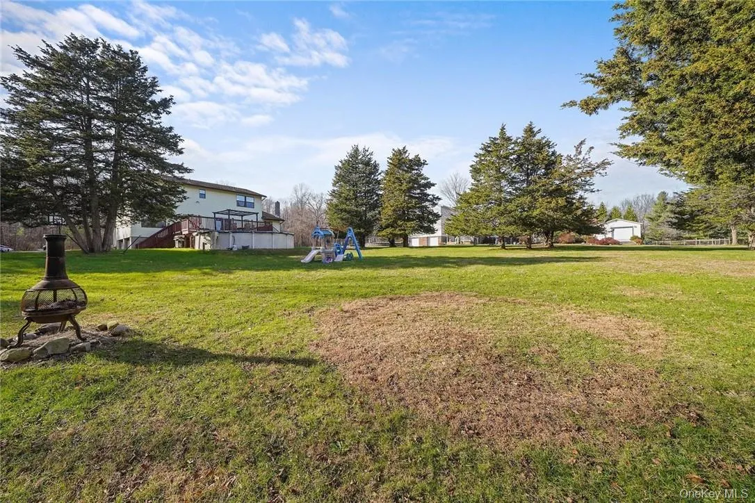 View of grassy yard featuring a playground View of grassy yard featuring a playground