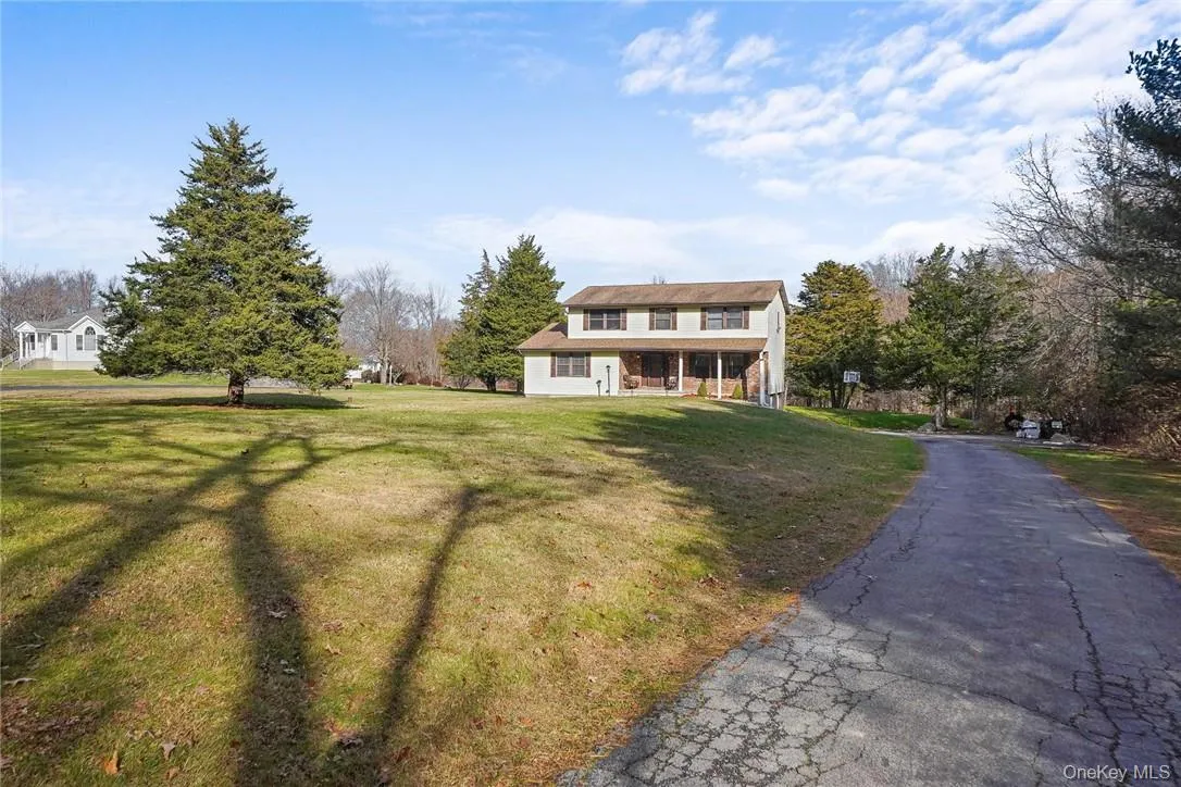 Traditional-style house featuring a front yard Traditional-style house featuring a front yard