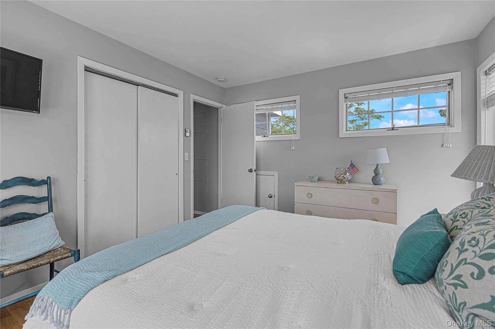 Bedroom featuring a closet and wood finished floors Bedroom featuring a closet and wood finished floors