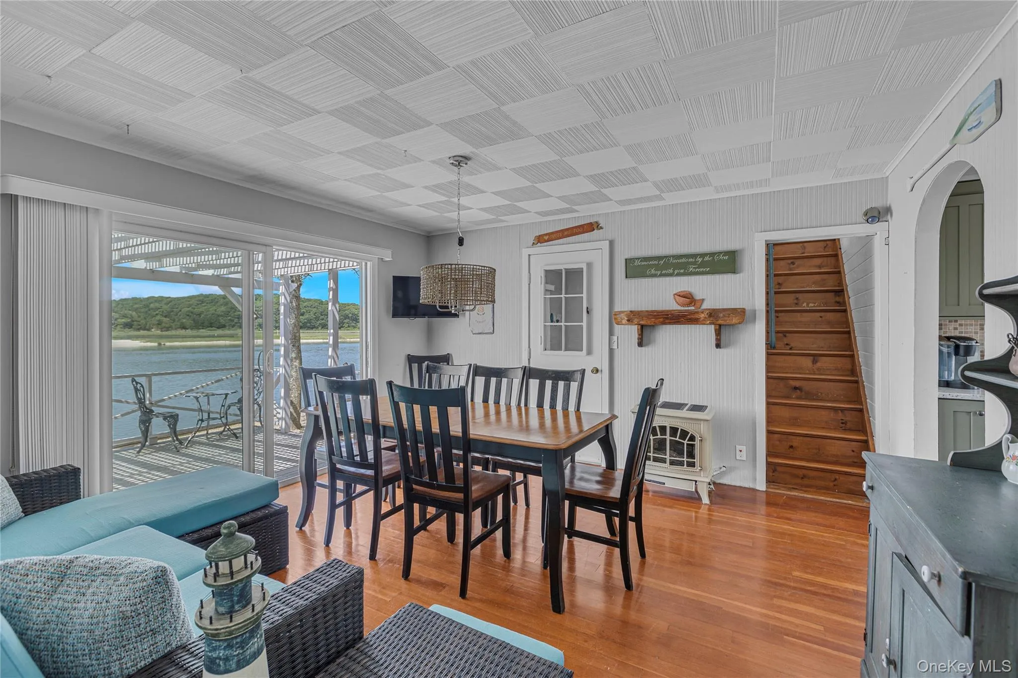 Dining room with arched walkways, light wood-type flooring, and heating unit Dining room with arched walkways, light wood-type flooring, and heating unit
