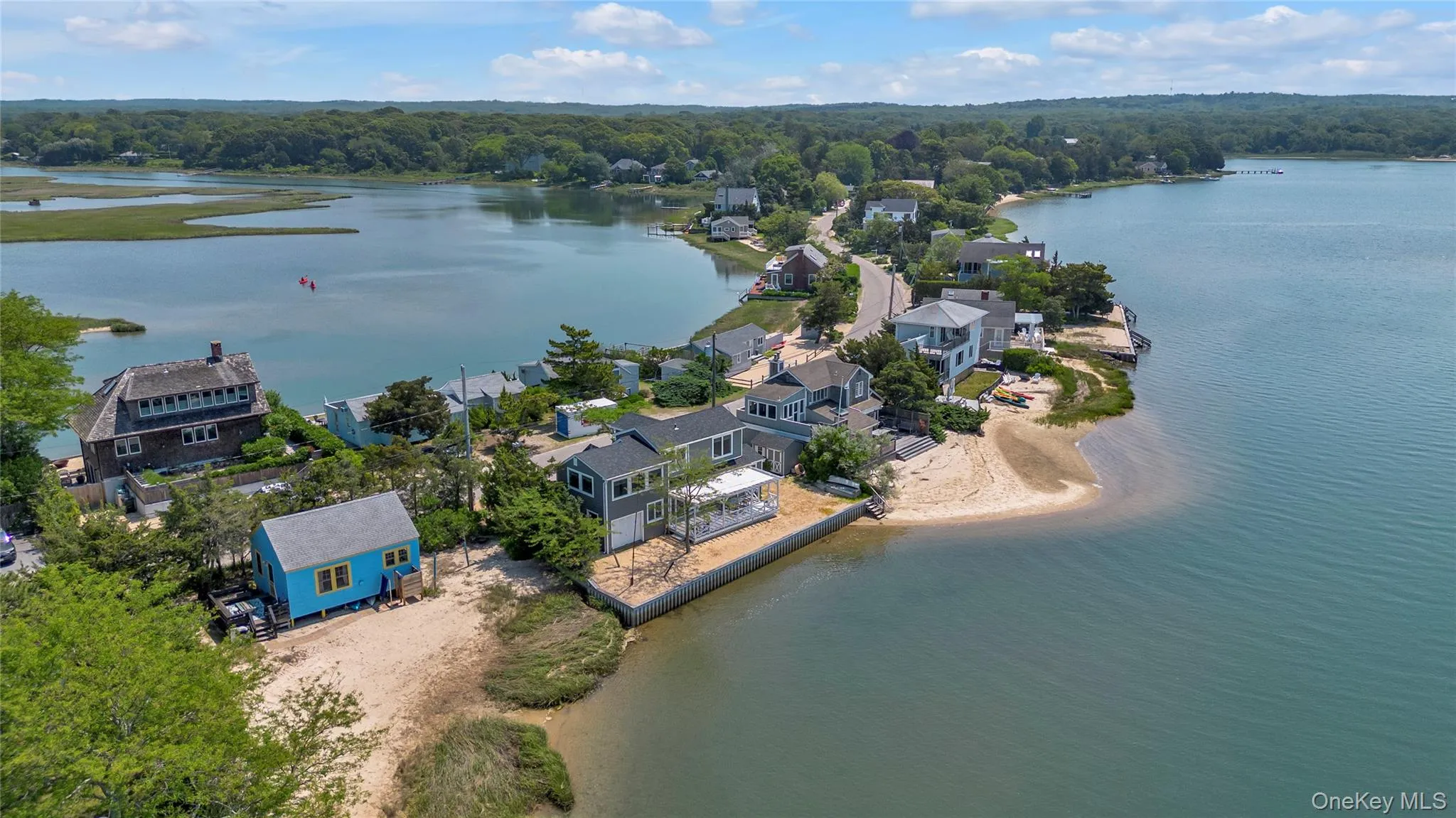 Aerial perspective of suburban area featuring a nearby body of water Aerial perspective of suburban area featuring a nearby body of water