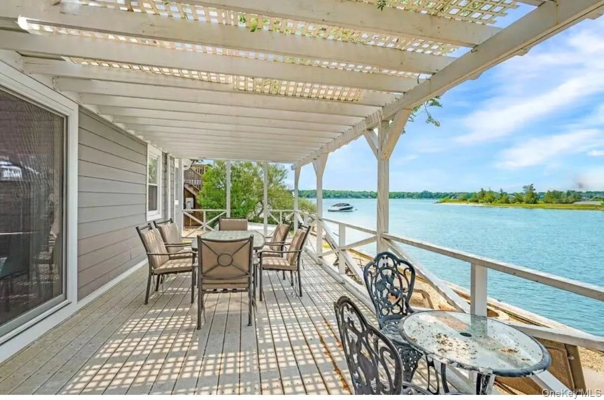 covered seating and dining area overlooking the water. covered seating and dining area overlooking the water.