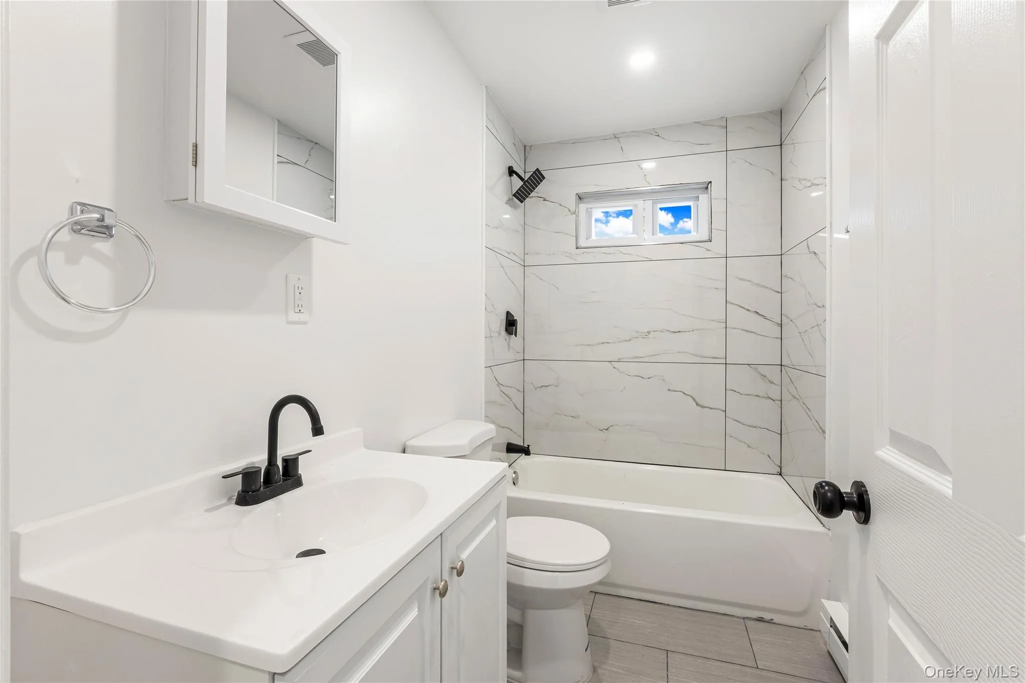 Full bath with ceramic tiled tub and granite topped vanity Full bath with ceramic tiled tub and granite topped vanity