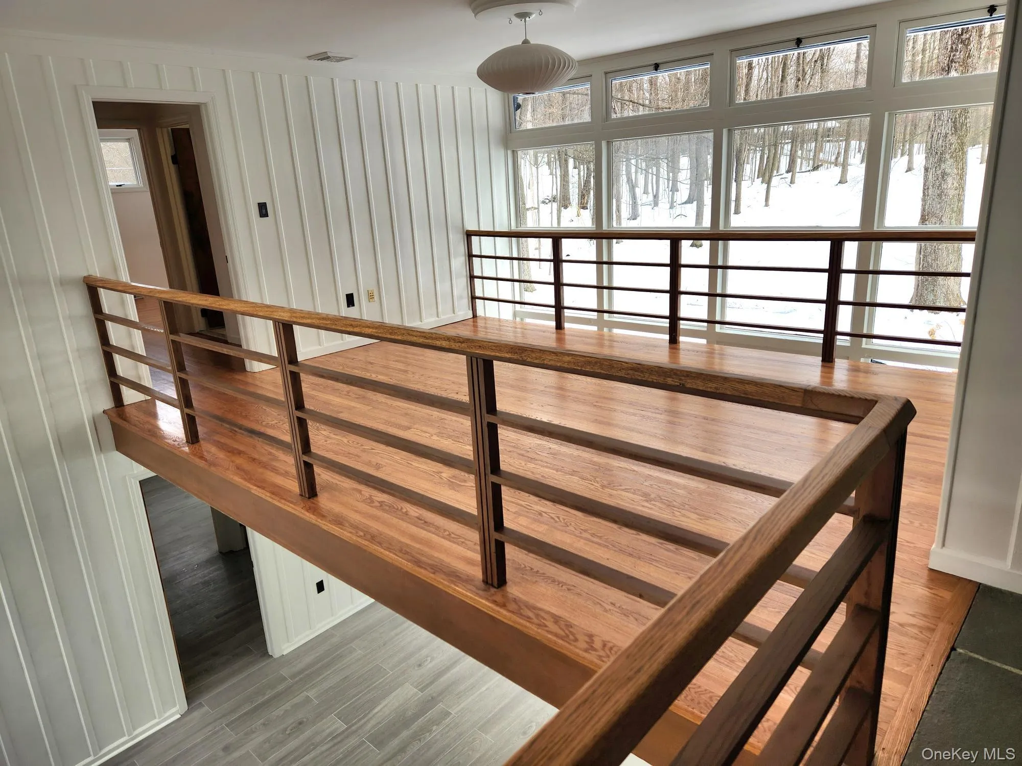 Stairs featuring wood finished floors Stairs featuring wood finished floors