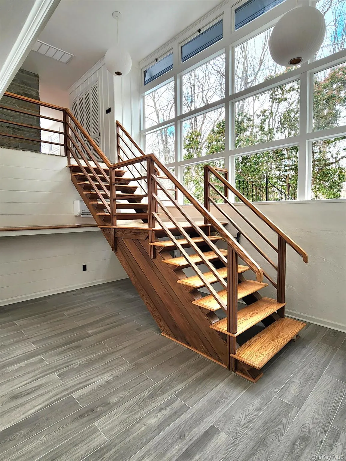Stairs featuring wood finished floors Stairs featuring wood finished floors