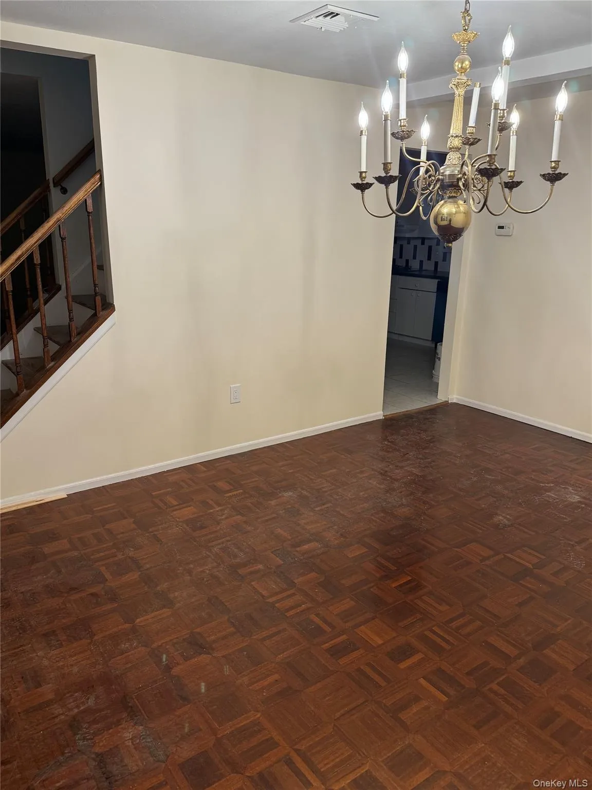 Natural wood parquet floor and brass chandelier Natural wood parquet floor and brass chandelier