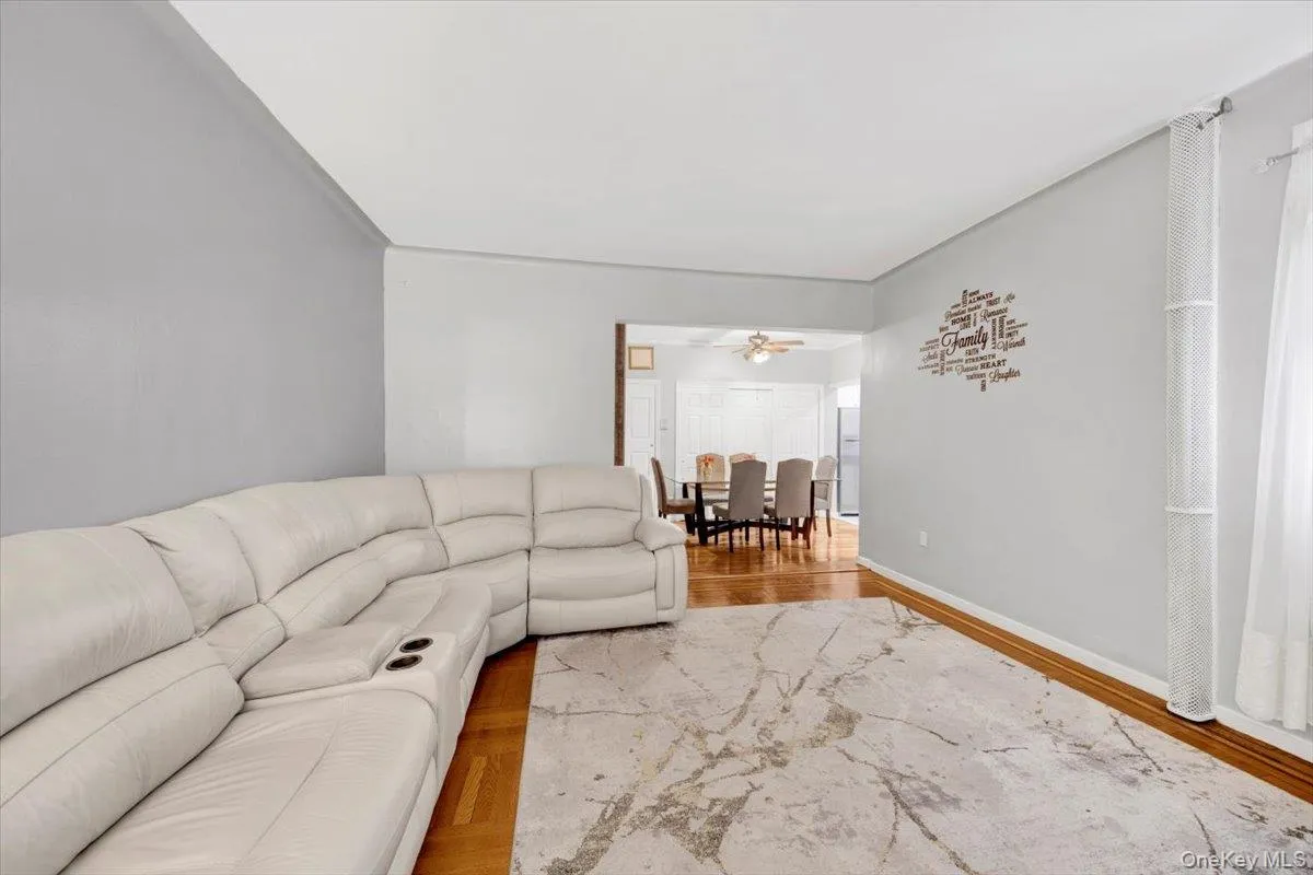 Living room with wood finished floors and a ceiling fan Living room with wood finished floors and a ceiling fan