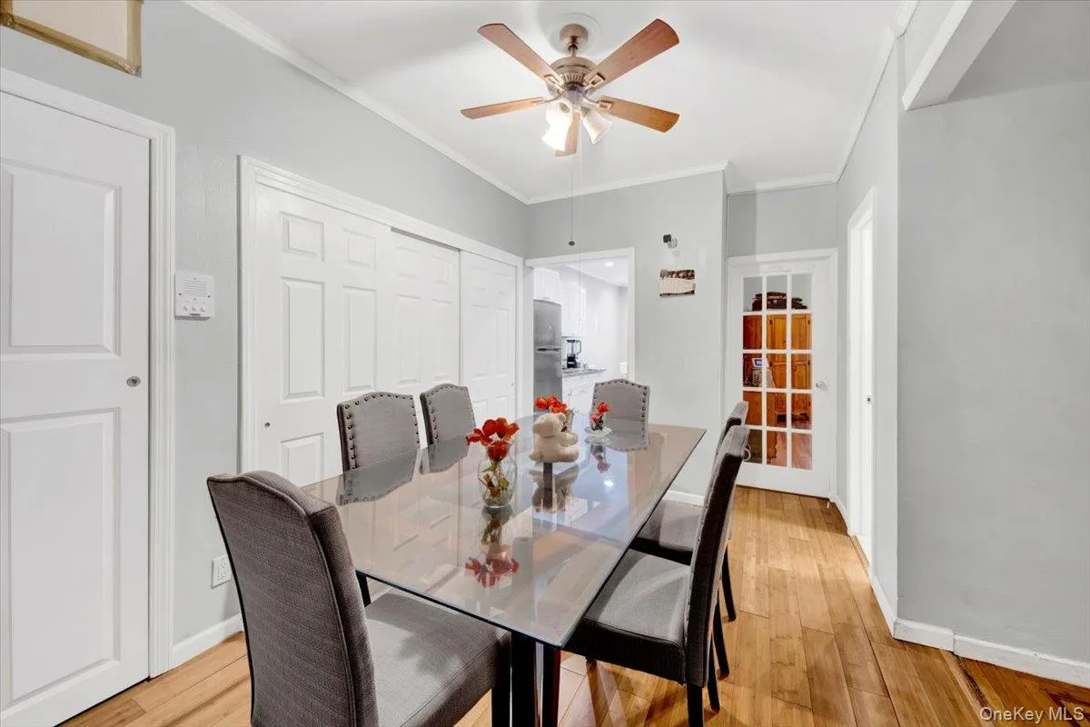 Dining space with ornamental molding, light wood finished floors, and ceiling fan Dining space with ornamental molding, light wood finished floors, and ceiling fan