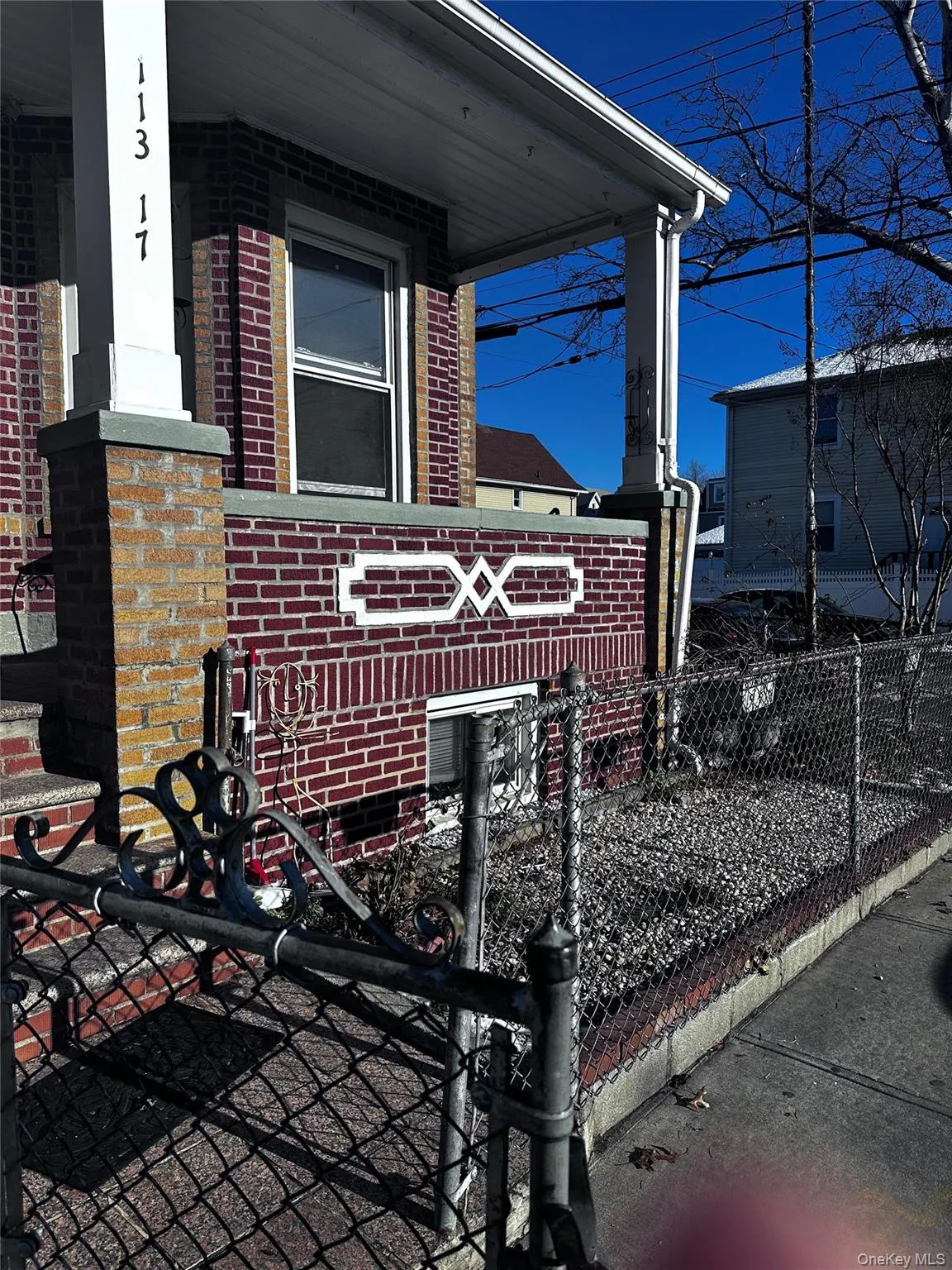 Exterior view of a fenced front yard, brick siding, and a gate Exterior view of a fenced front yard, brick siding, and a gate
