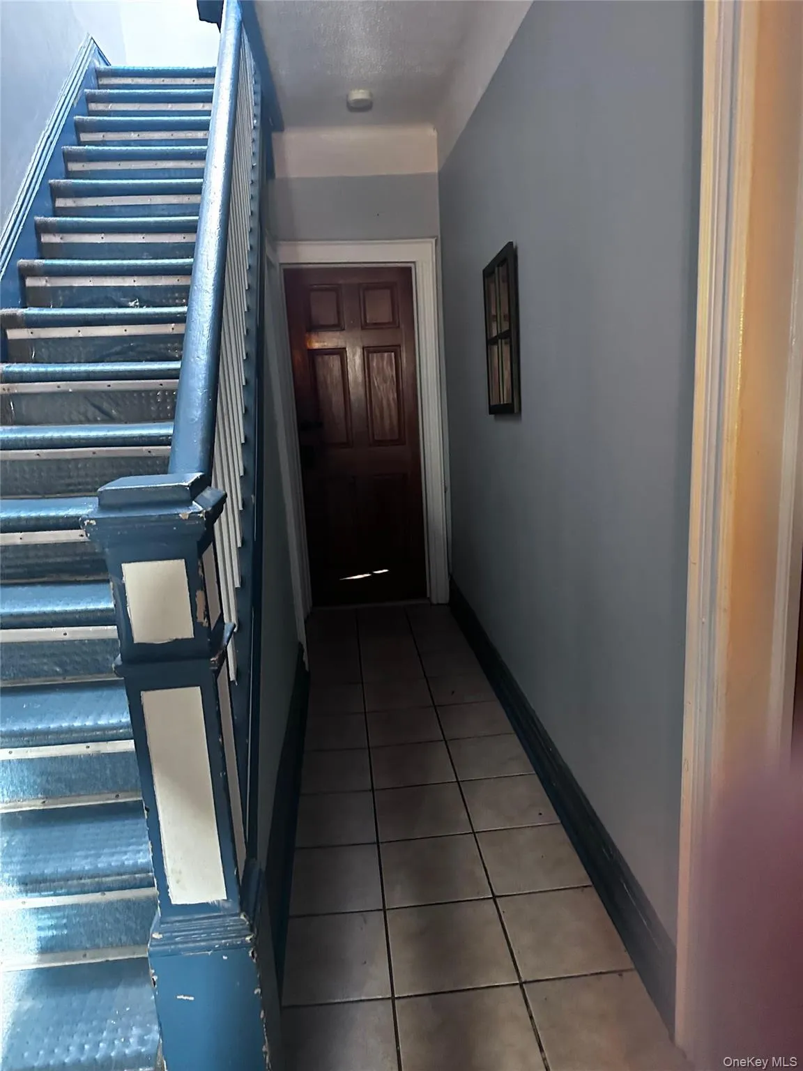 Stairs featuring baseboards and tile patterned flooring Stairs featuring baseboards and tile patterned flooring