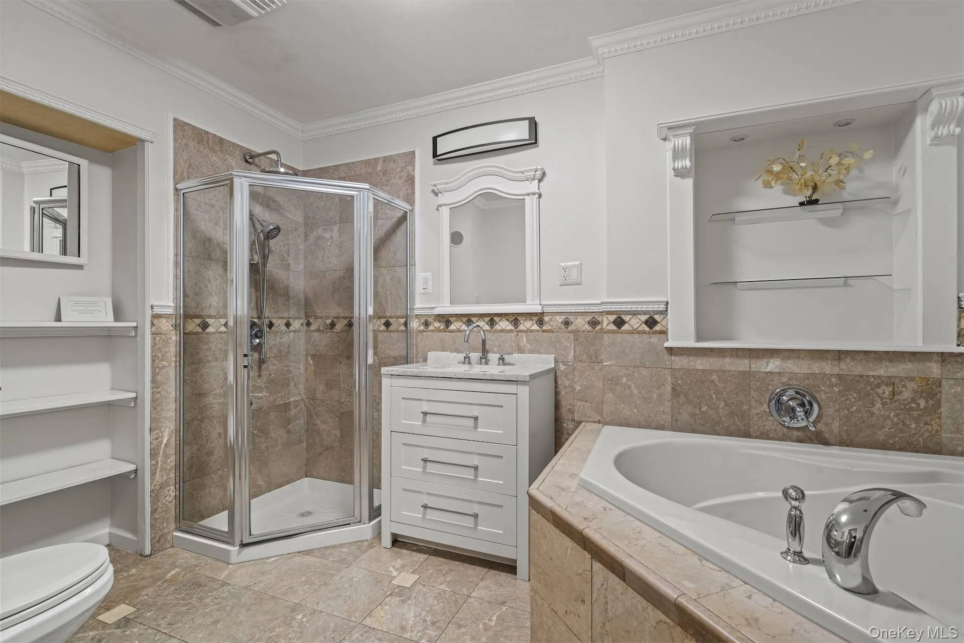 Full bath with a shower stall, a garden tub, vanity, crown molding, and tile walls Full bath with a shower stall, a garden tub, vanity, crown molding, and tile walls