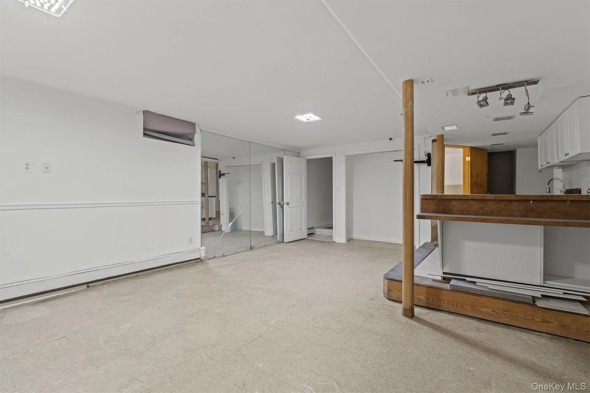 Finished basement with light floors and baseboard heating Finished basement with light floors and baseboard heating