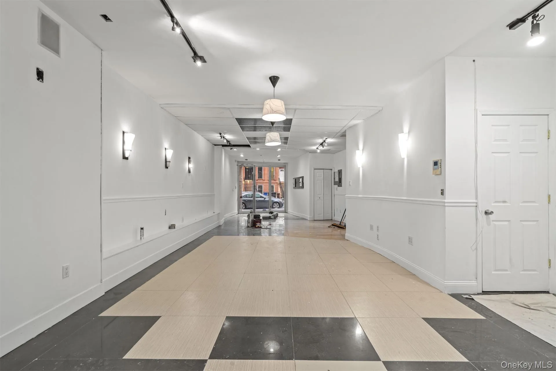 Hallway with rail lighting and inlaid floor details Hallway with rail lighting and inlaid floor details