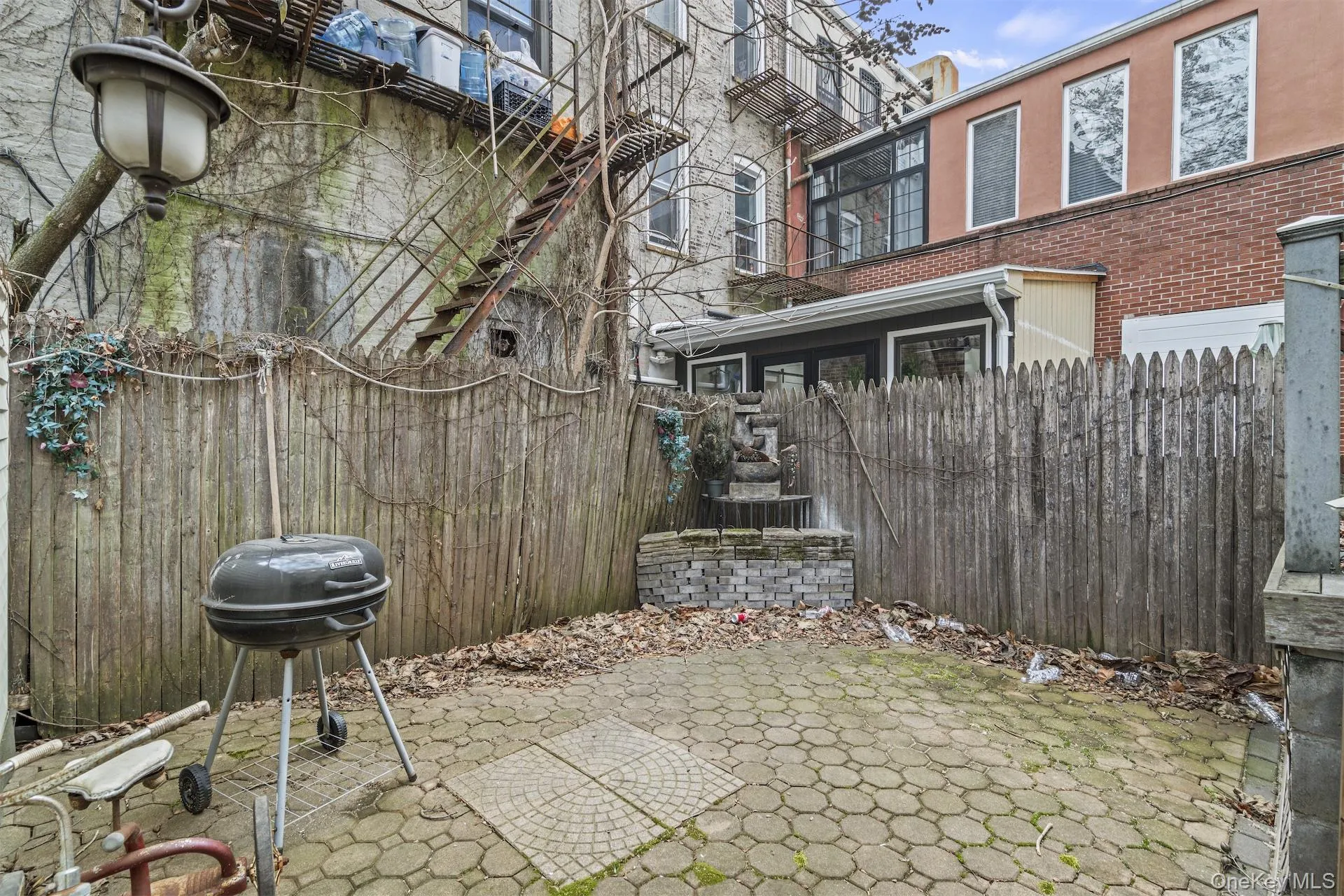 Fenced backyard featuring a patio and a grill Fenced backyard featuring a patio and a grill