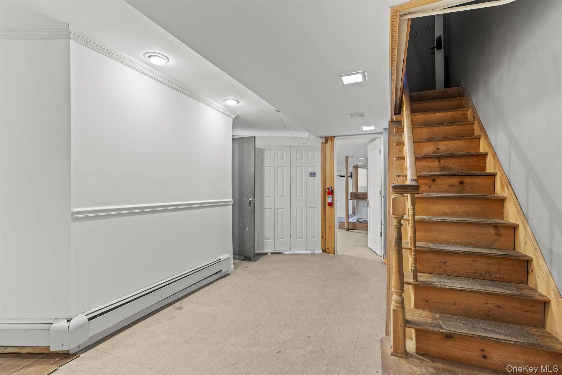 Stairway featuring a baseboard heating unit and recessed lighting Stairway featuring a baseboard heating unit and recessed lighting