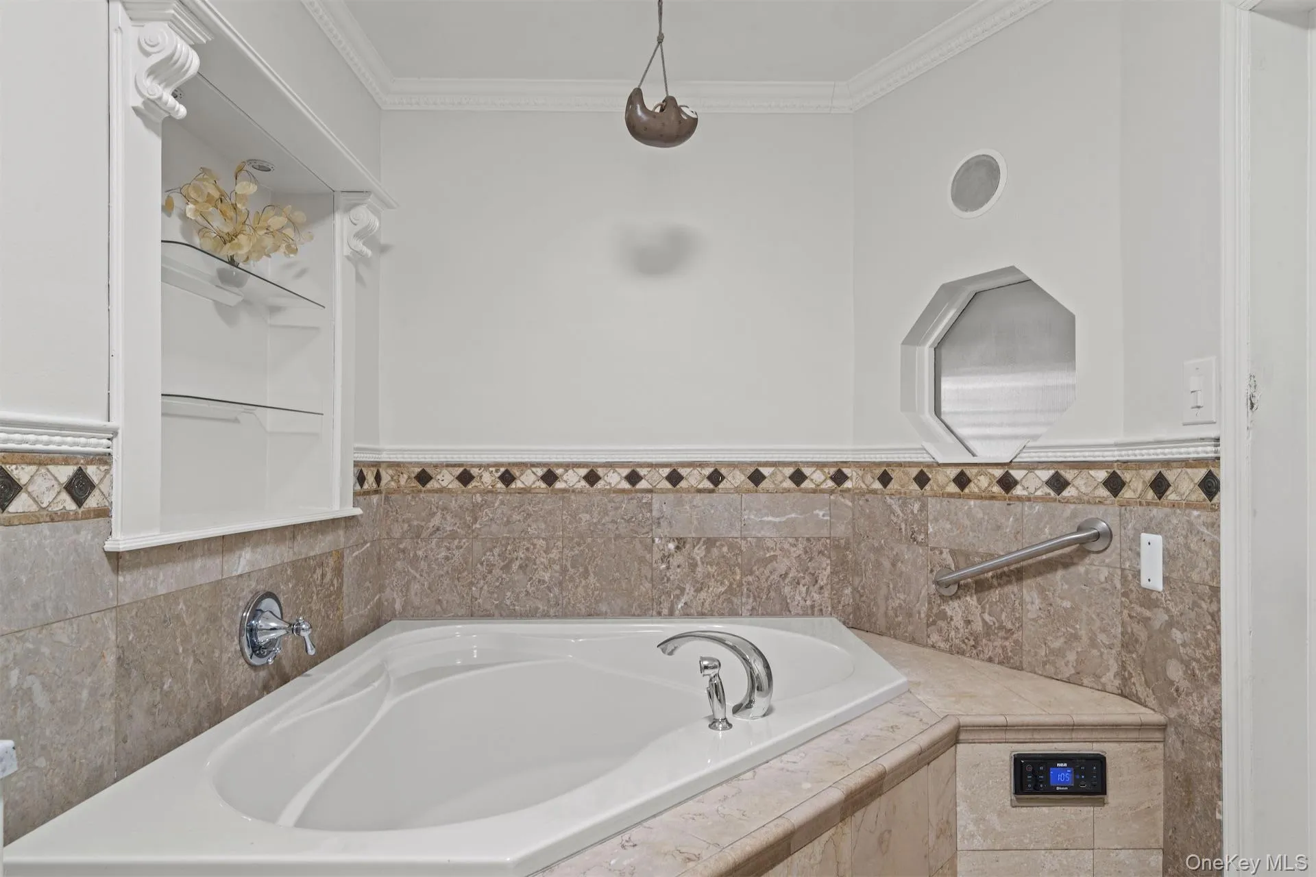 Full bathroom featuring a garden tub and ornamental molding Full bathroom featuring a garden tub and ornamental molding