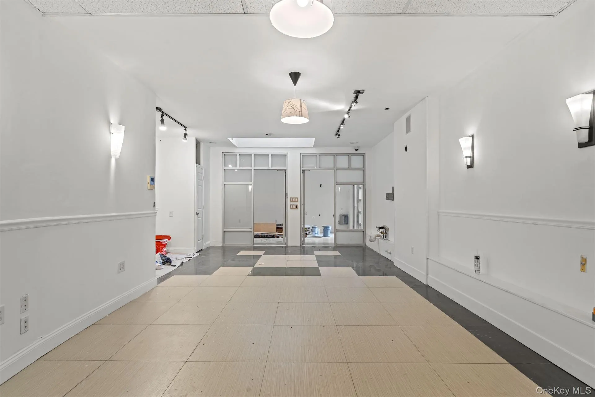 Corridor with track lighting and inlaid floor details Corridor with track lighting and inlaid floor details