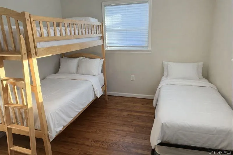 Bedroom with wood finished floors and baseboards Bedroom with wood finished floors and baseboards