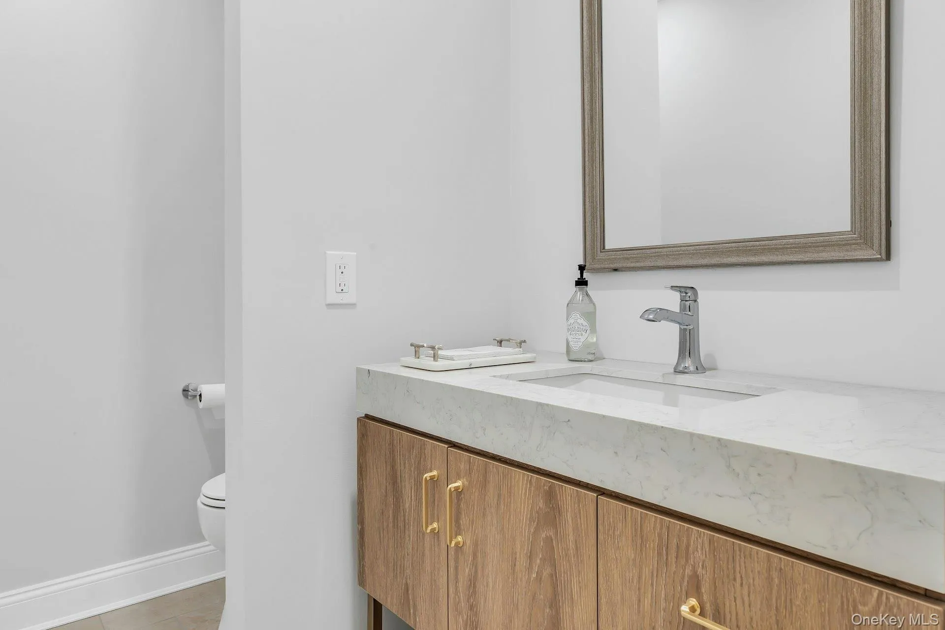 New Powder room with custom vanity and mirror, quartz countertop. tile floor. New Powder room with custom vanity and mirror, quartz countertop. tile floor.