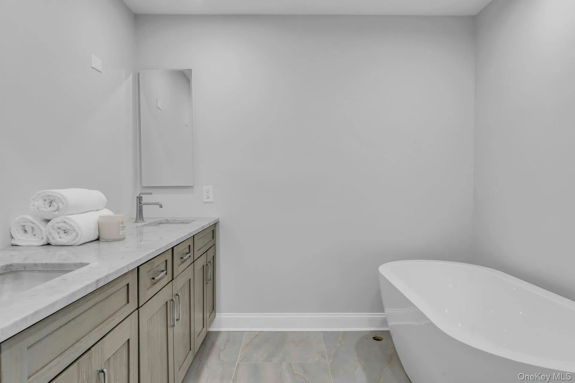 Primary bathroom suite with custom cabinetry double vanities with double sinks and two mirrors above the double vanity. Primary bathroom suite with custom cabinetry double vanities with double sinks and two mirrors above the double vanity.