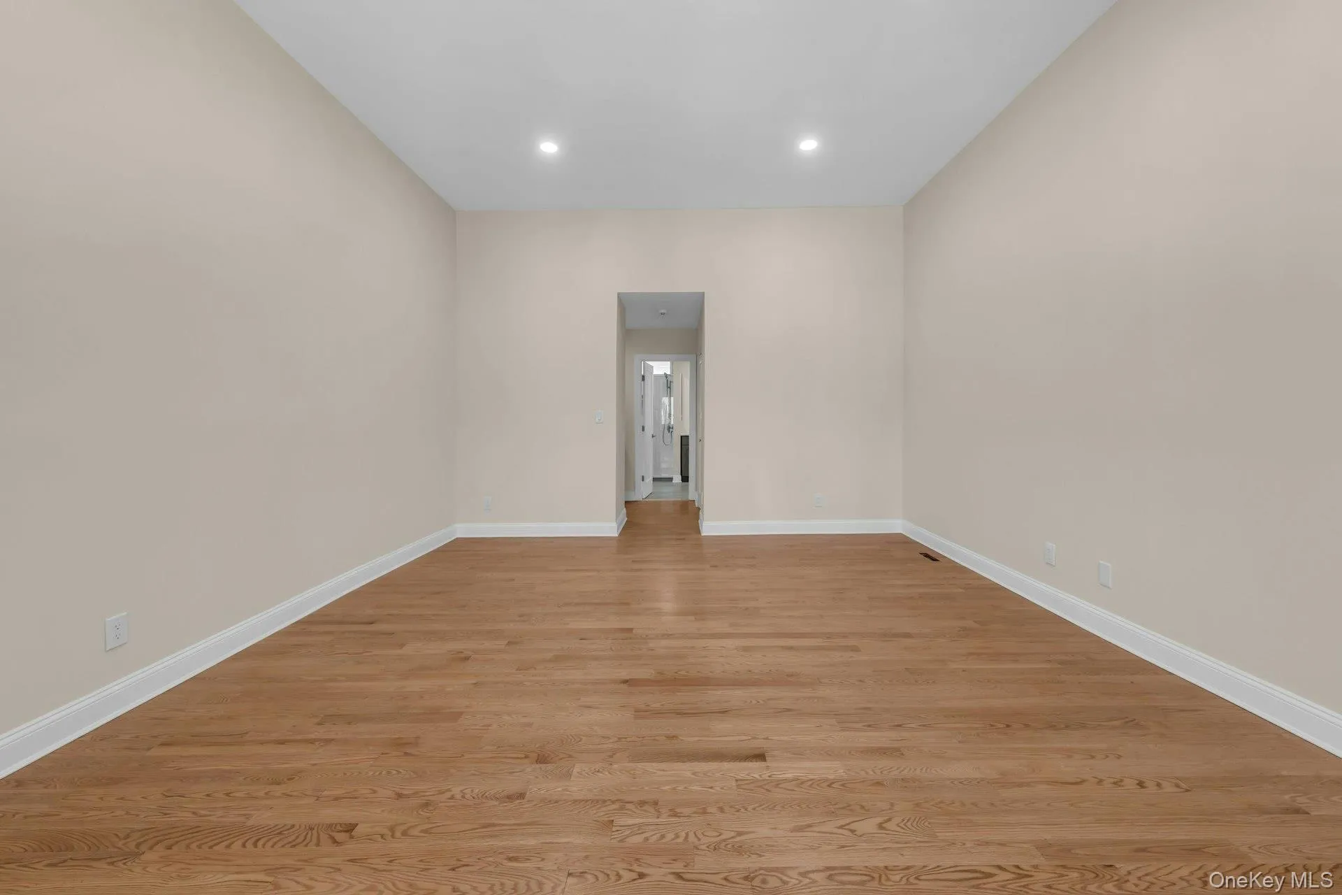 Primary bedroom spacious with recessed lighting new oak hardwood floors. Primary bedroom spacious with recessed lighting new oak hardwood floors.