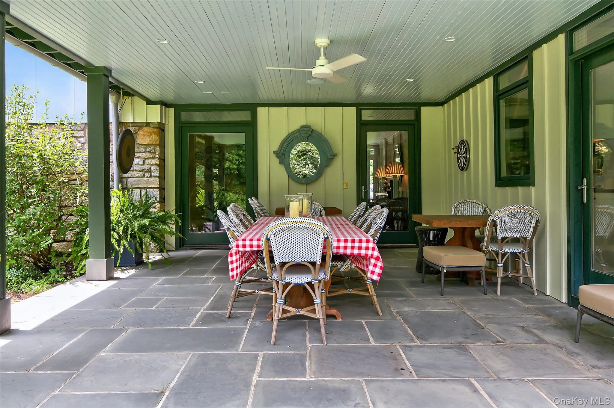 Covered terrace with dining area overlooking the gardens Covered terrace with dining area overlooking the gardens