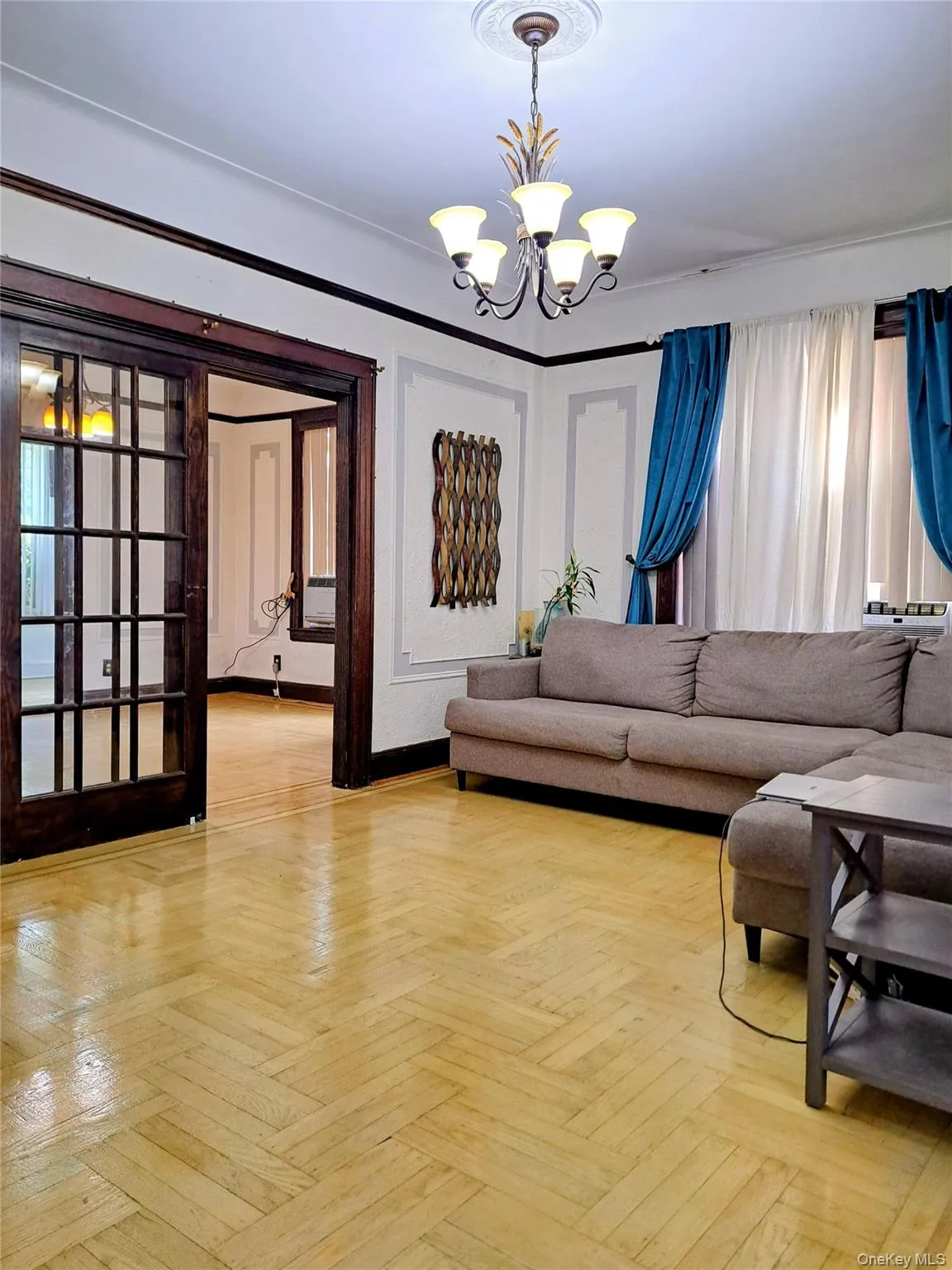 Living area featuring a chandelier Living area featuring a chandelier