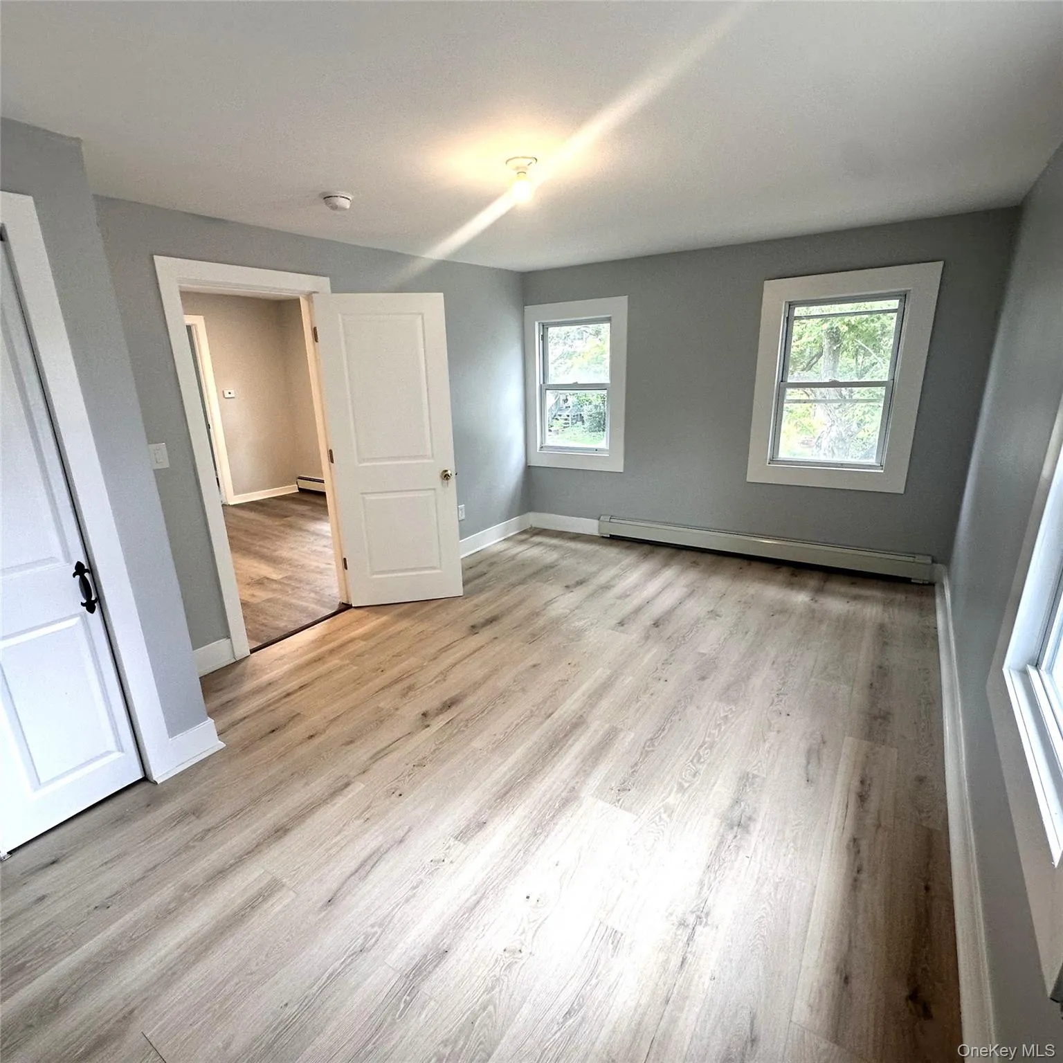 Different angle of the bedroom showing multiple windows and closet Different angle of the bedroom showing multiple windows and closet