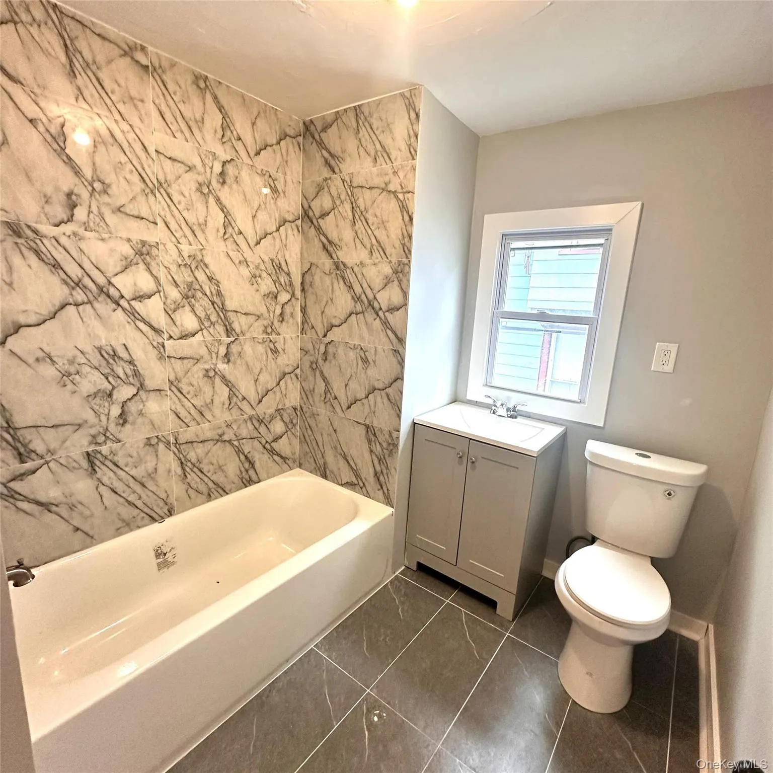 Full bathroom tile floor and tile in the bath tube area Full bathroom tile floor and tile in the bath tube area