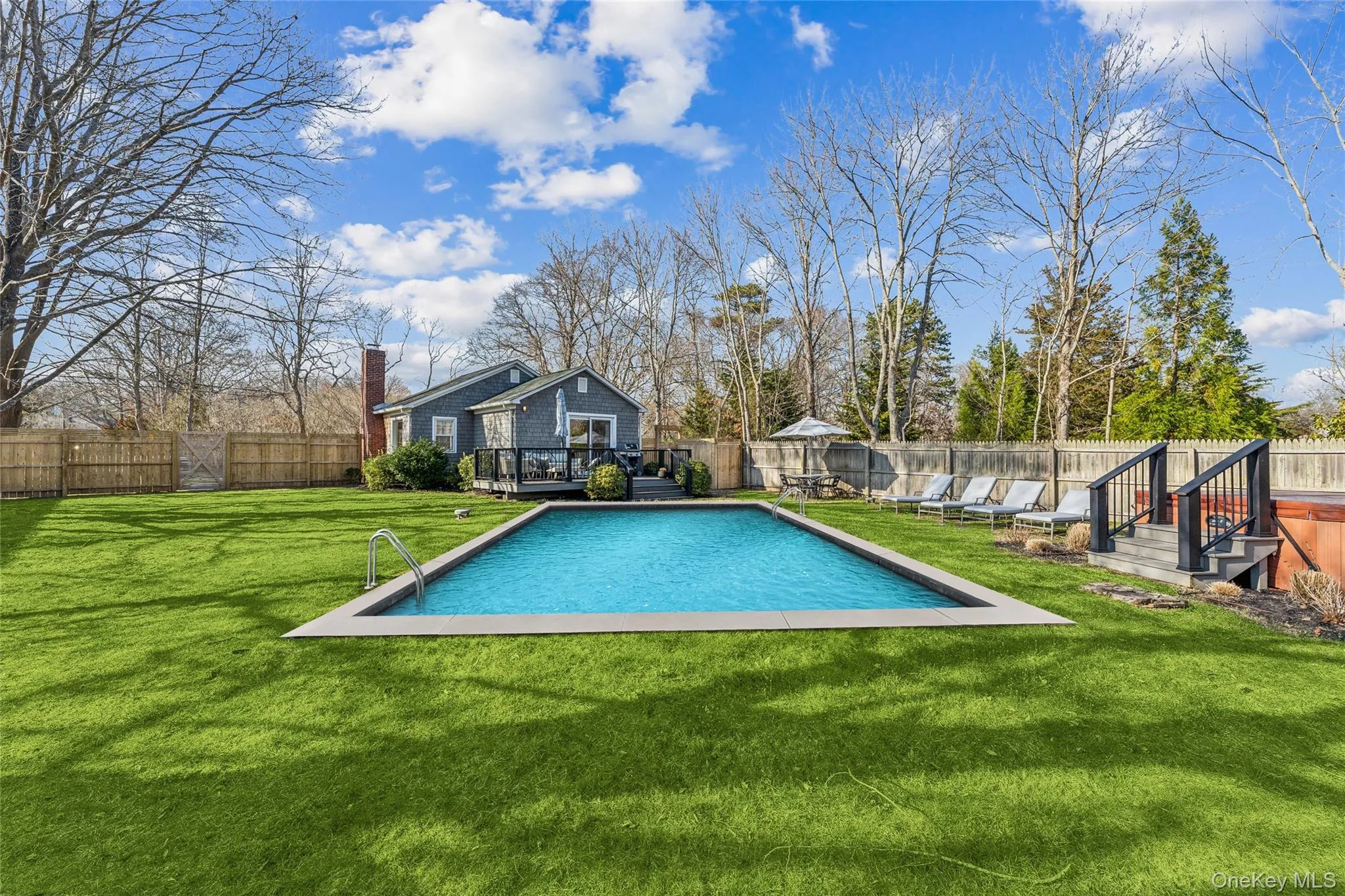 View of swimming pool with a deck and a yard View of swimming pool with a deck and a yard